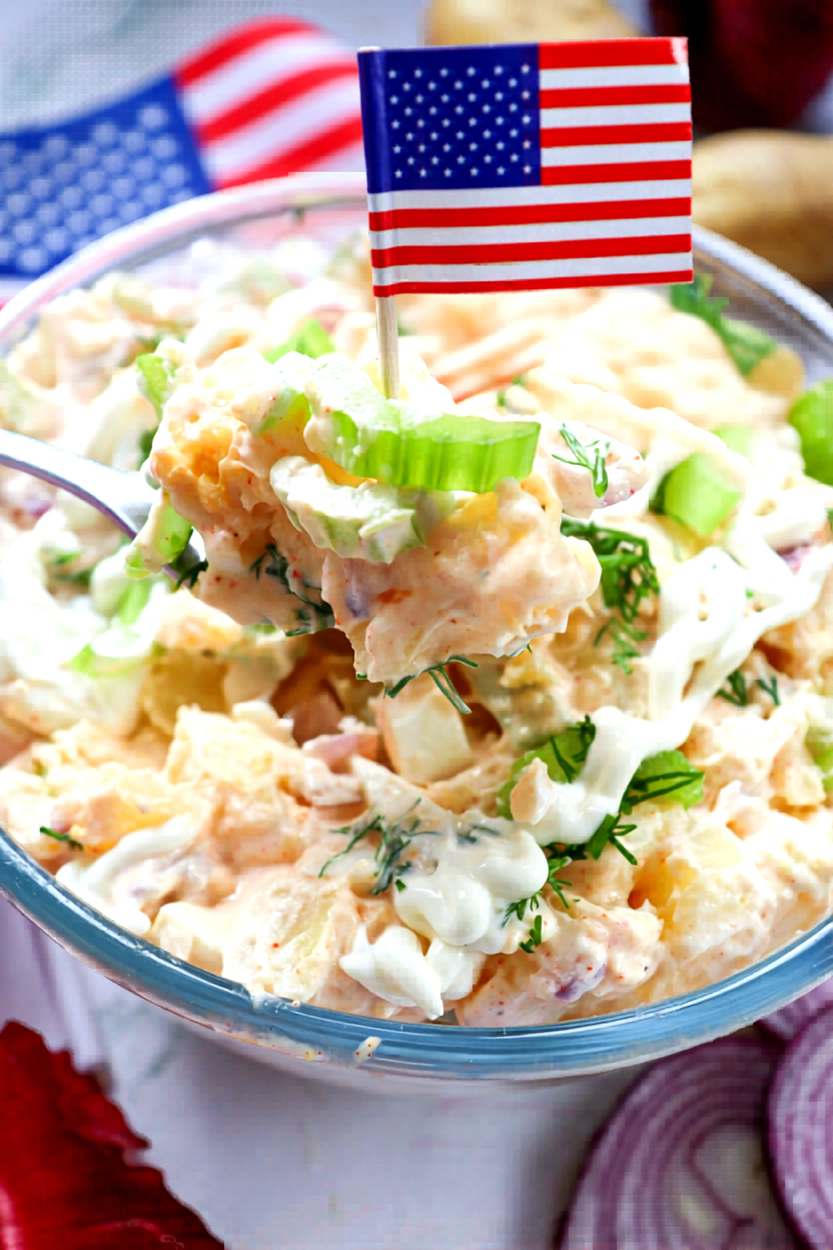 Closeup of classic potato salad with celery and mini American flags