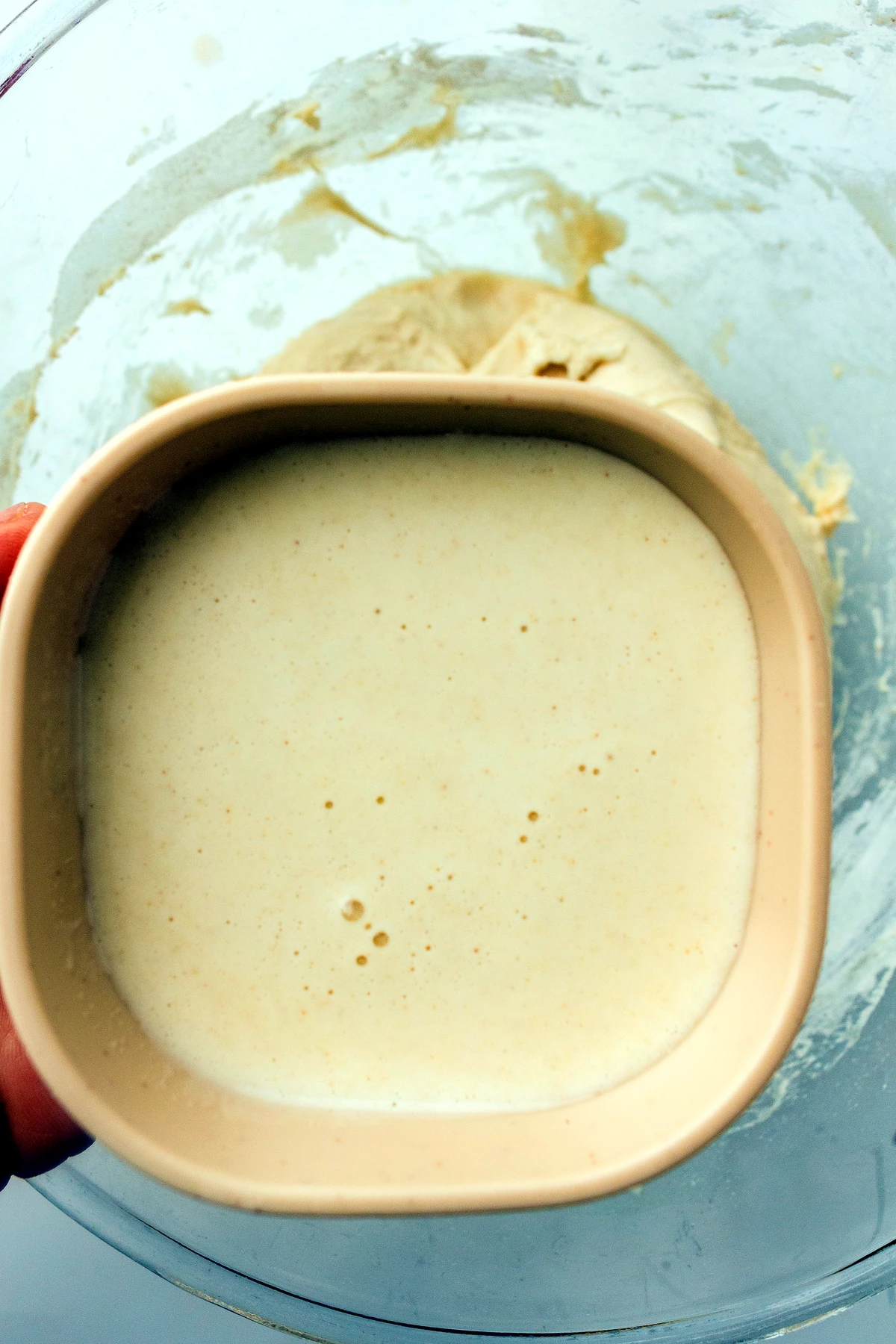 Water and sourdough starter mixed in a bowl