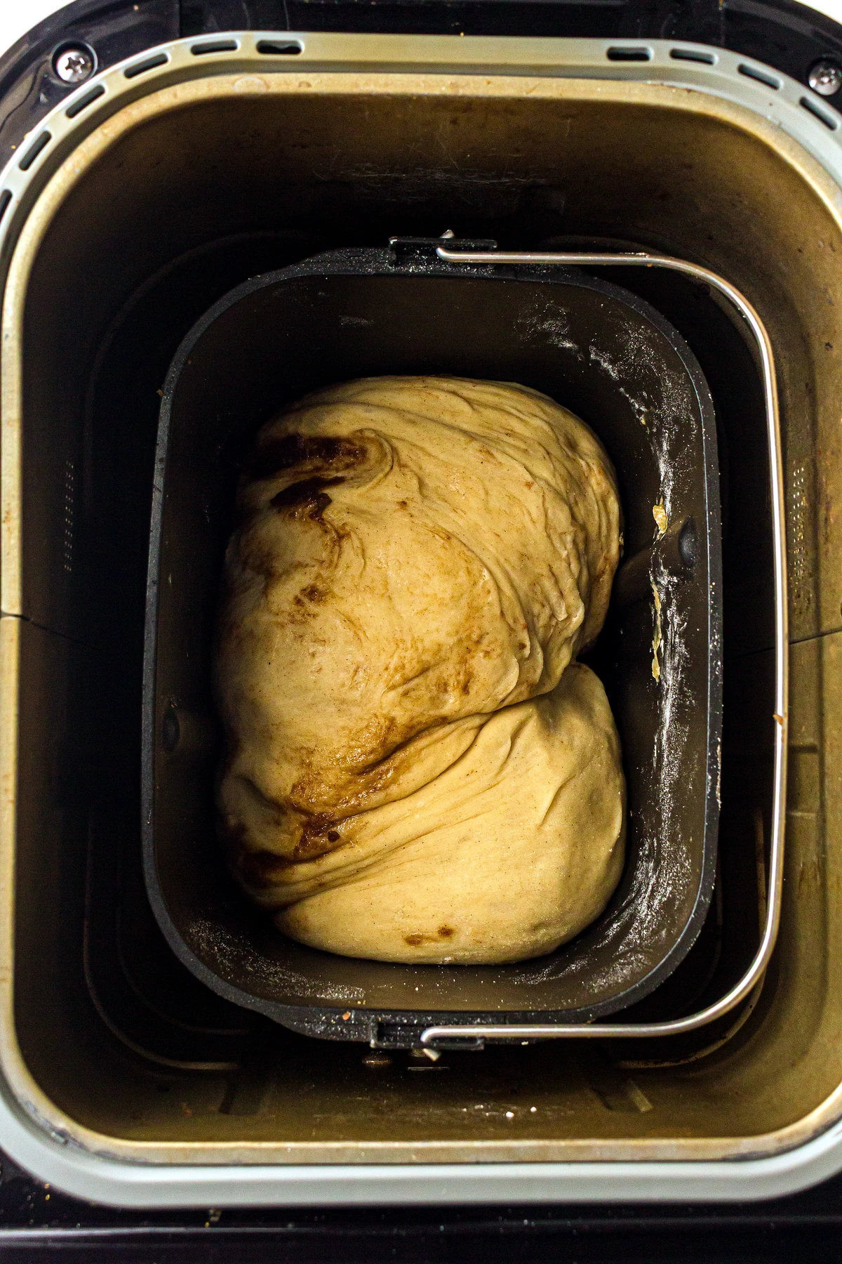 Rolled cinnamon swirl dough back in bread machine pan