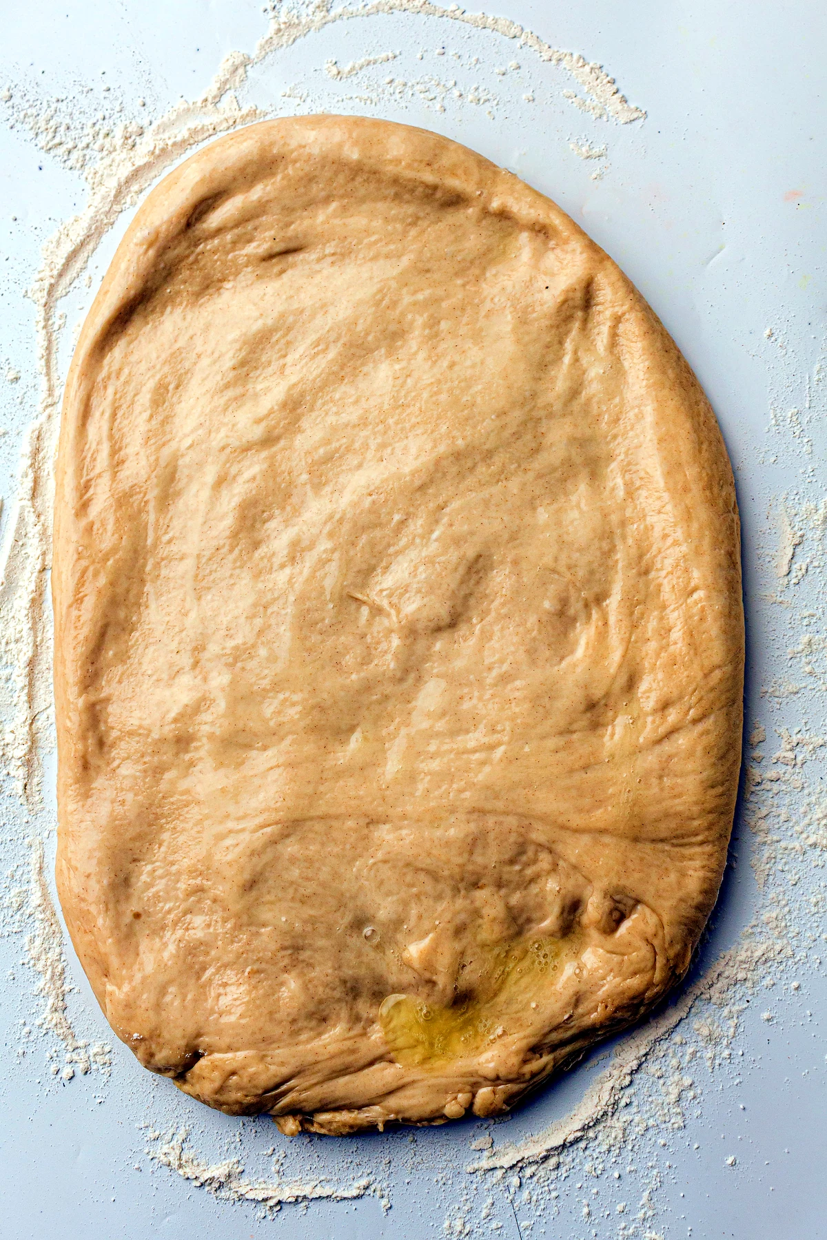 Melted butter brushed over dough