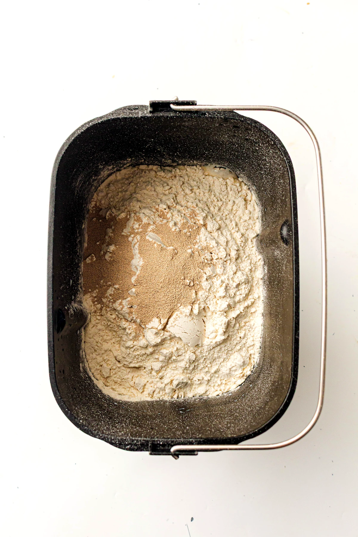Bread machine pan loaded with ingredients