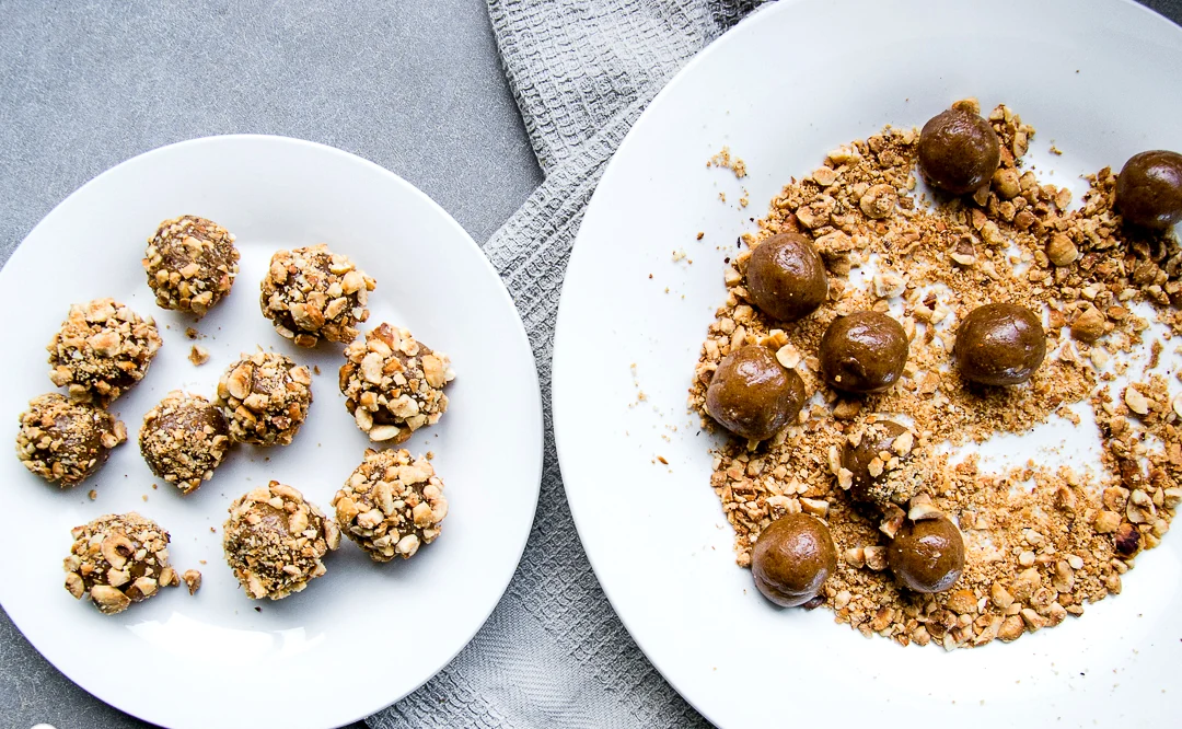 Coating caramel hazelnut balls in crushed hazelnuts