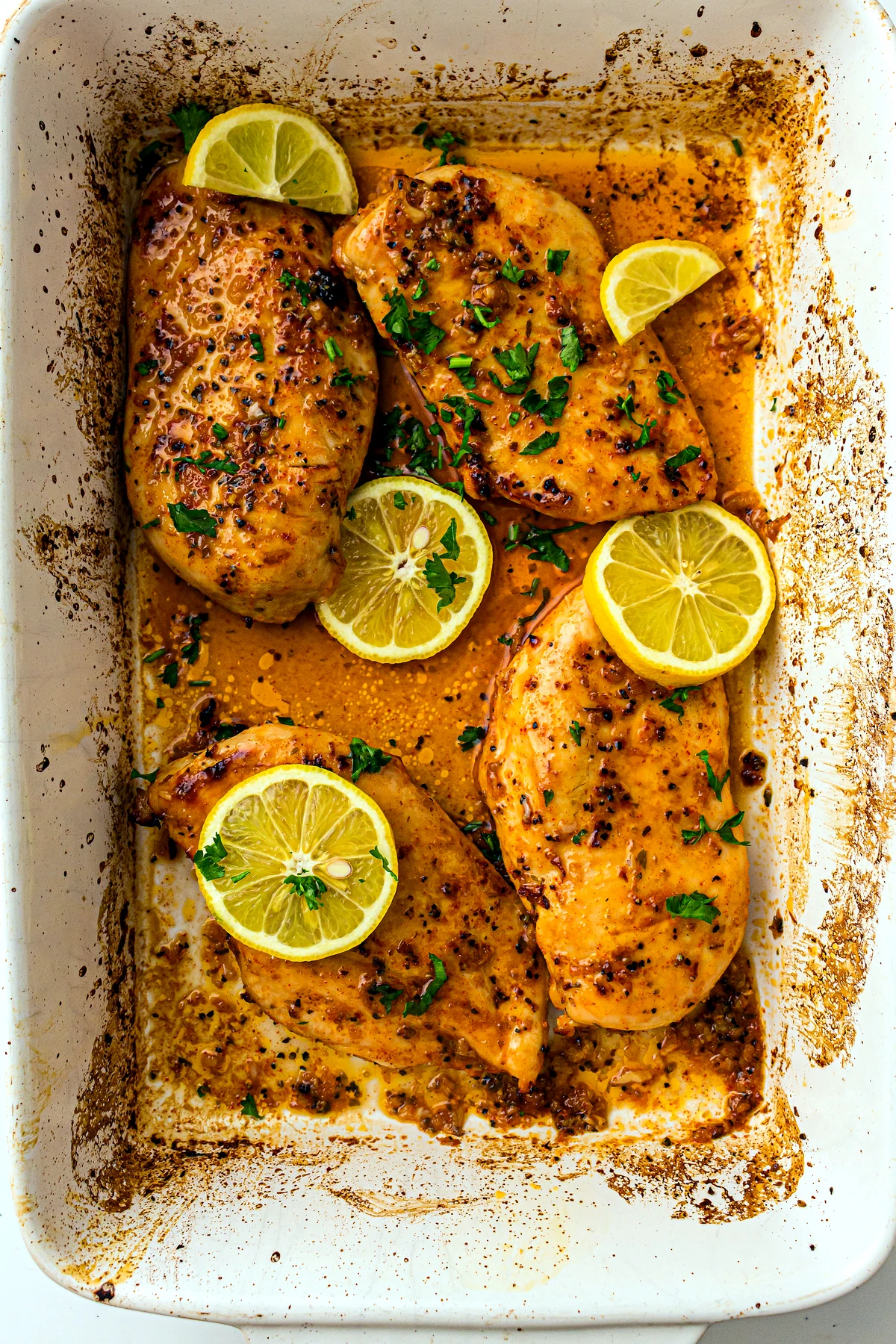 Baked lemon chicken garnished with lemon slices and parsley