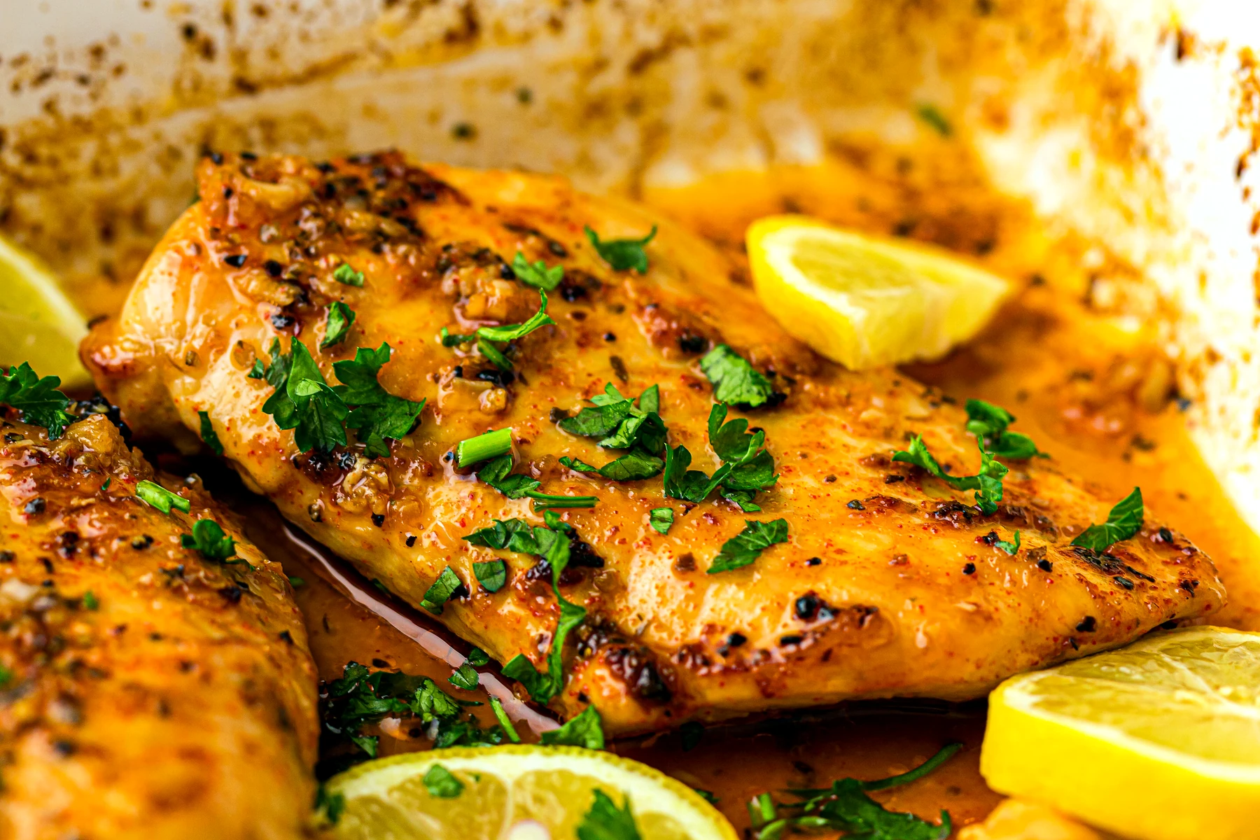 Pan of easy baked lemon chicken breasts finished in sauce