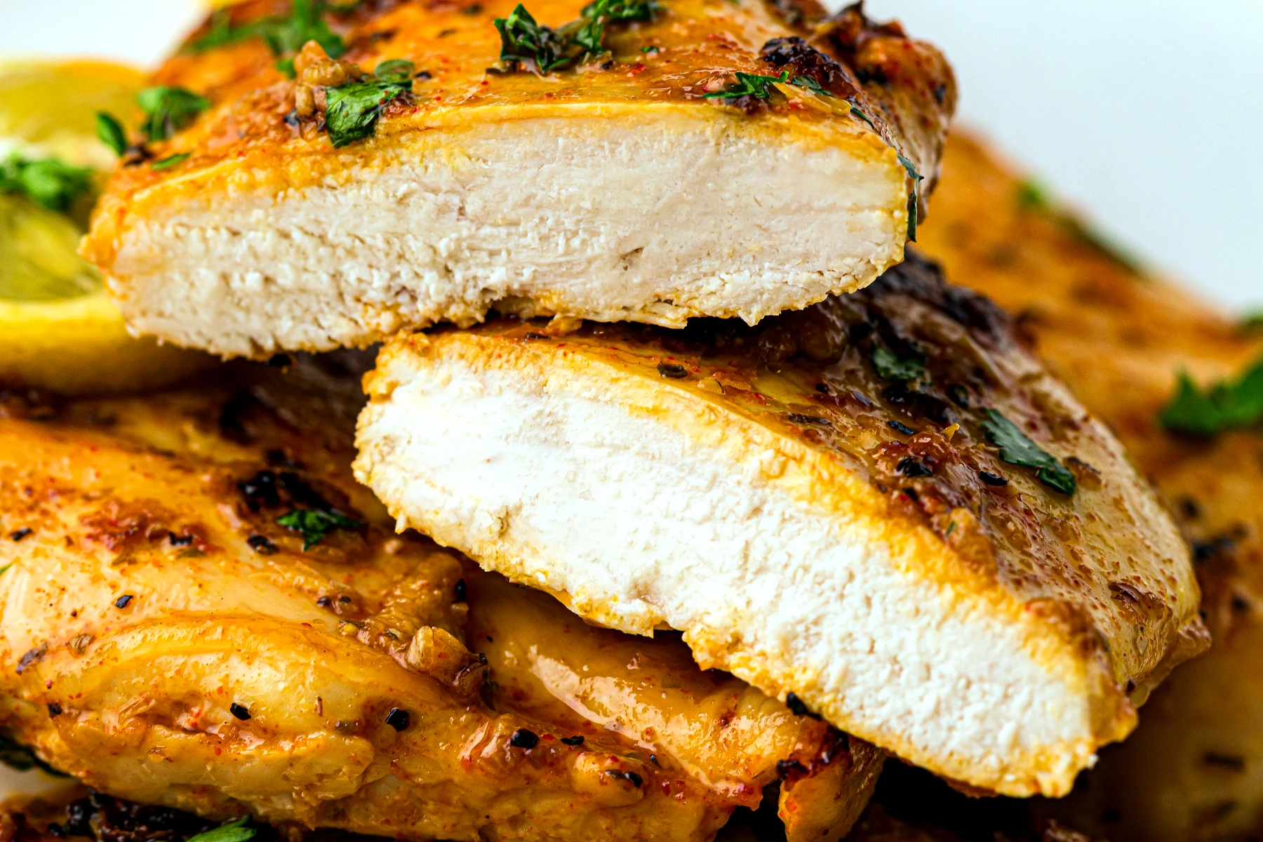 Sliced baked lemon chicken breast showing the center