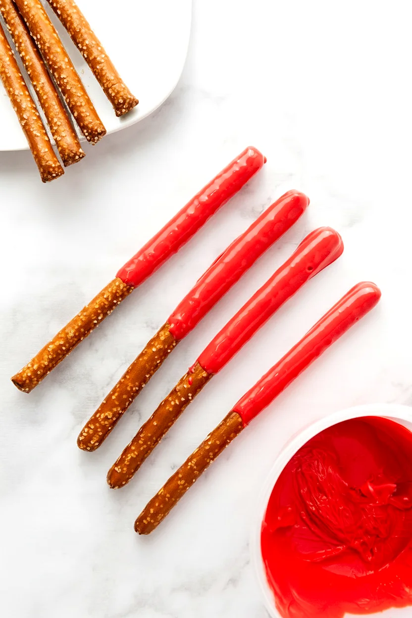 Pretzel rods dipped in red candy coating