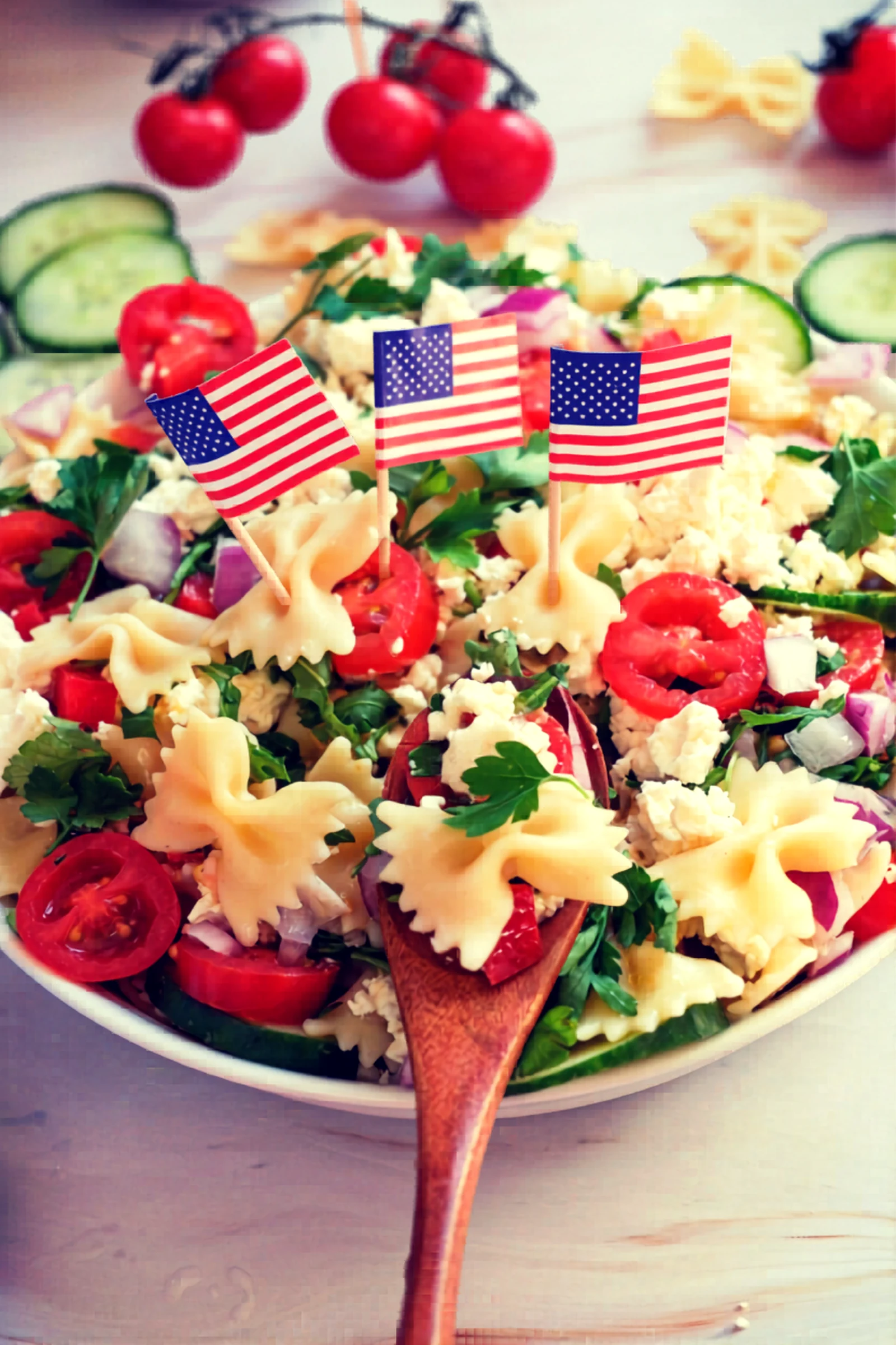 Finished Fourth of July pasta salad in a bowl with a serving spoon.