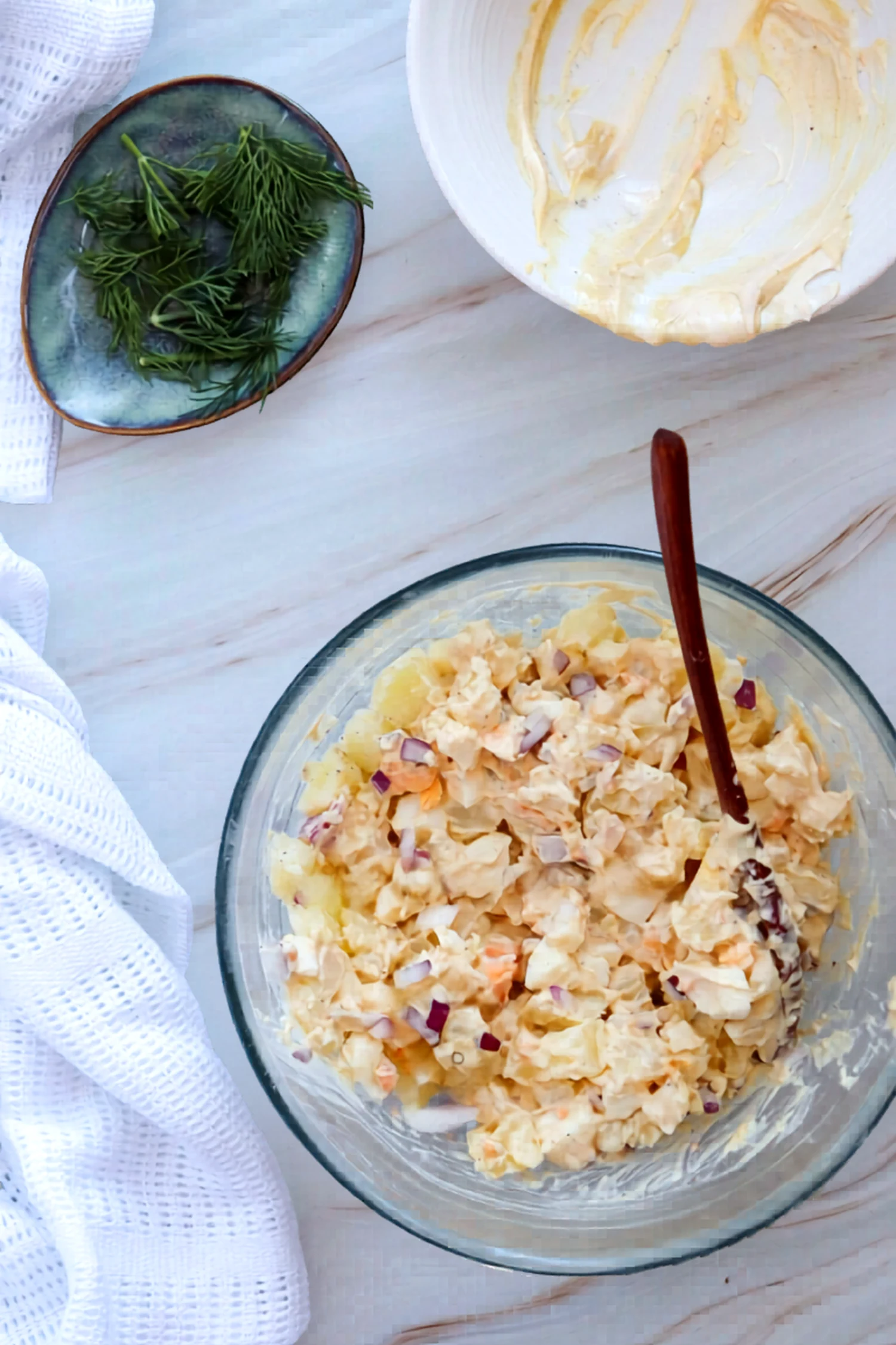 Potato salad mixed in a glass bowl