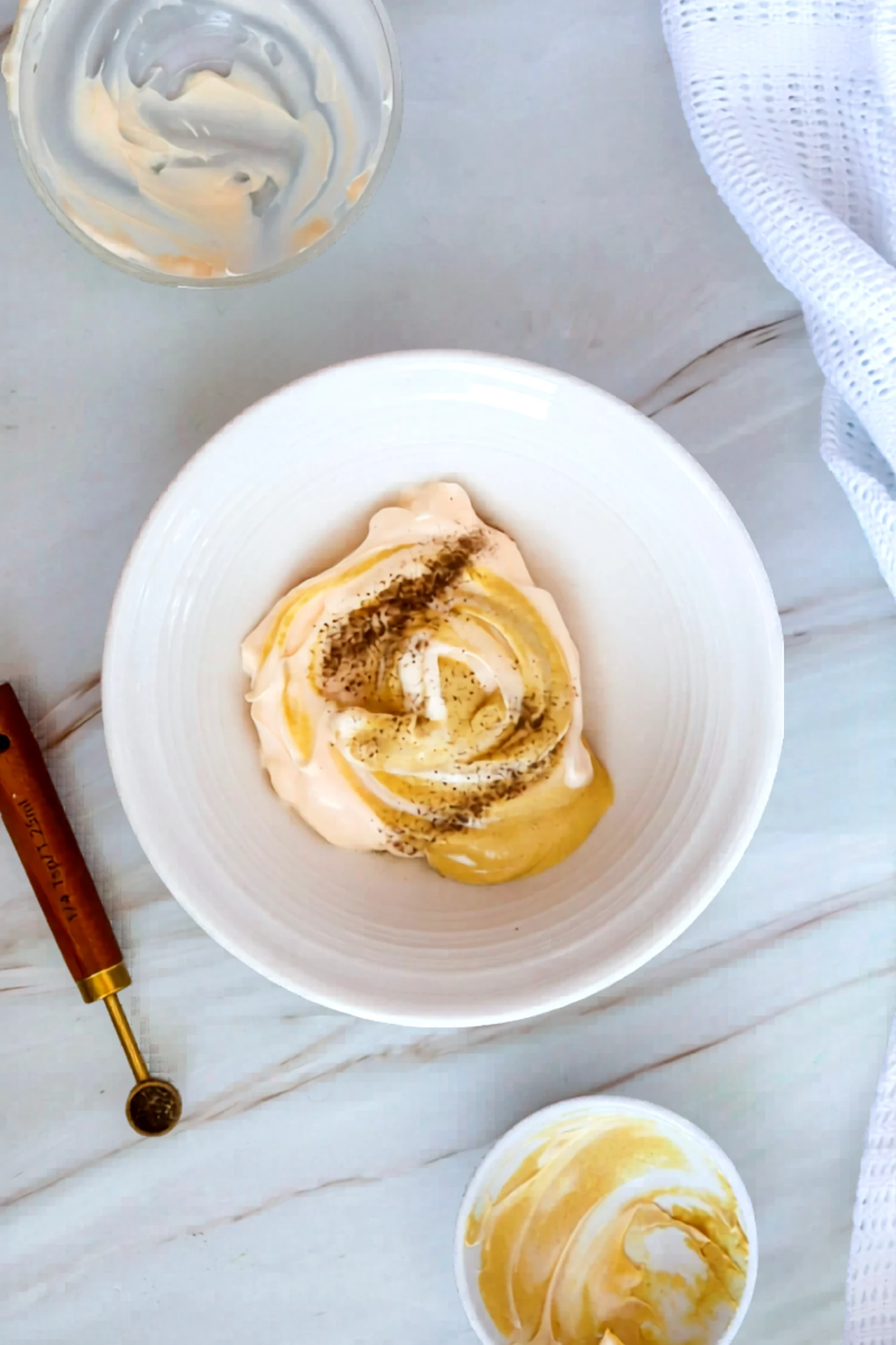 Mayonnaise and mustard mixed in a bowl