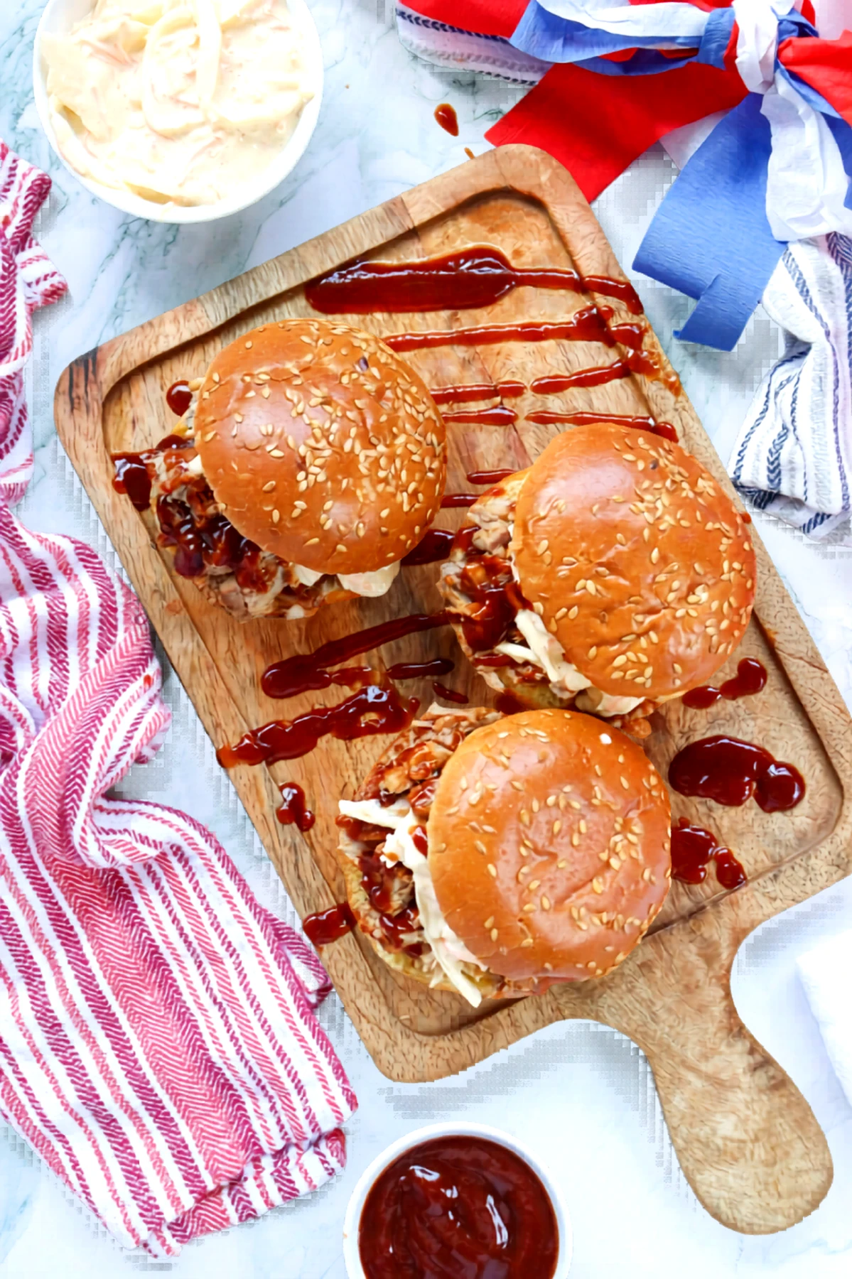Pulled pork sandwiches on a patriotic styled serving board.