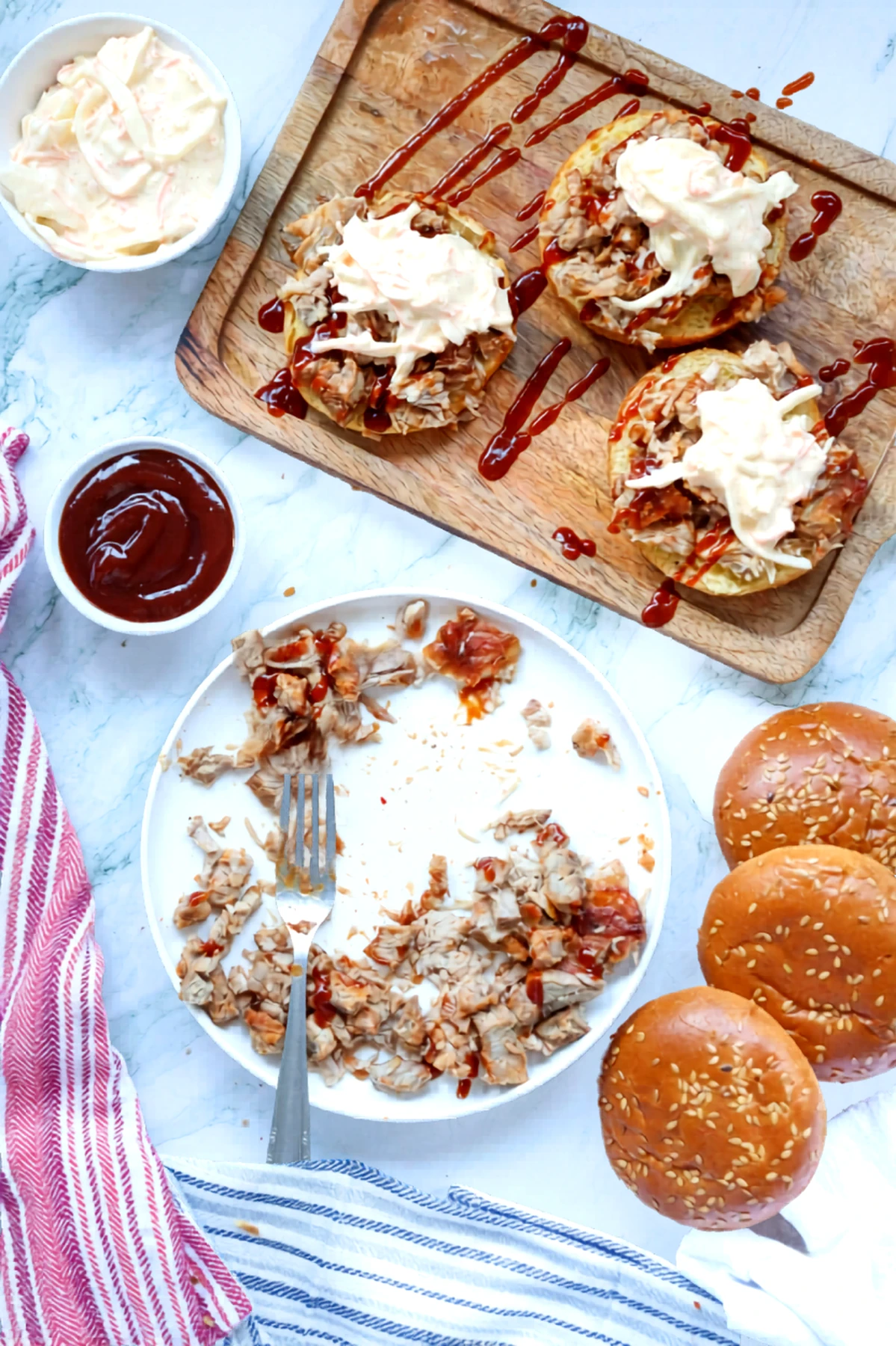 Pulled pork sandwiches topped with creamy coleslaw before adding the bun tops.
