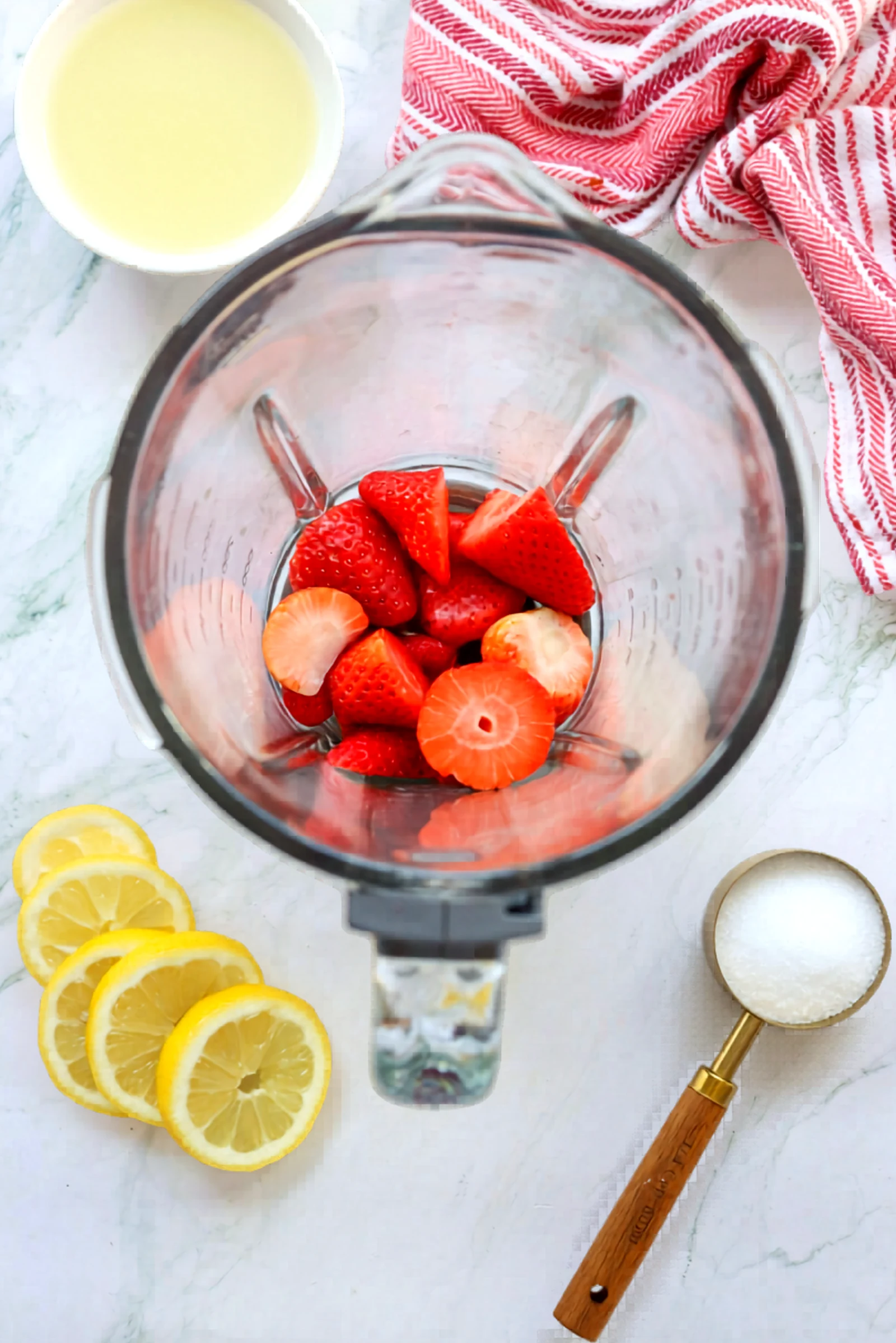 Strawberries added to the blender for lemonade