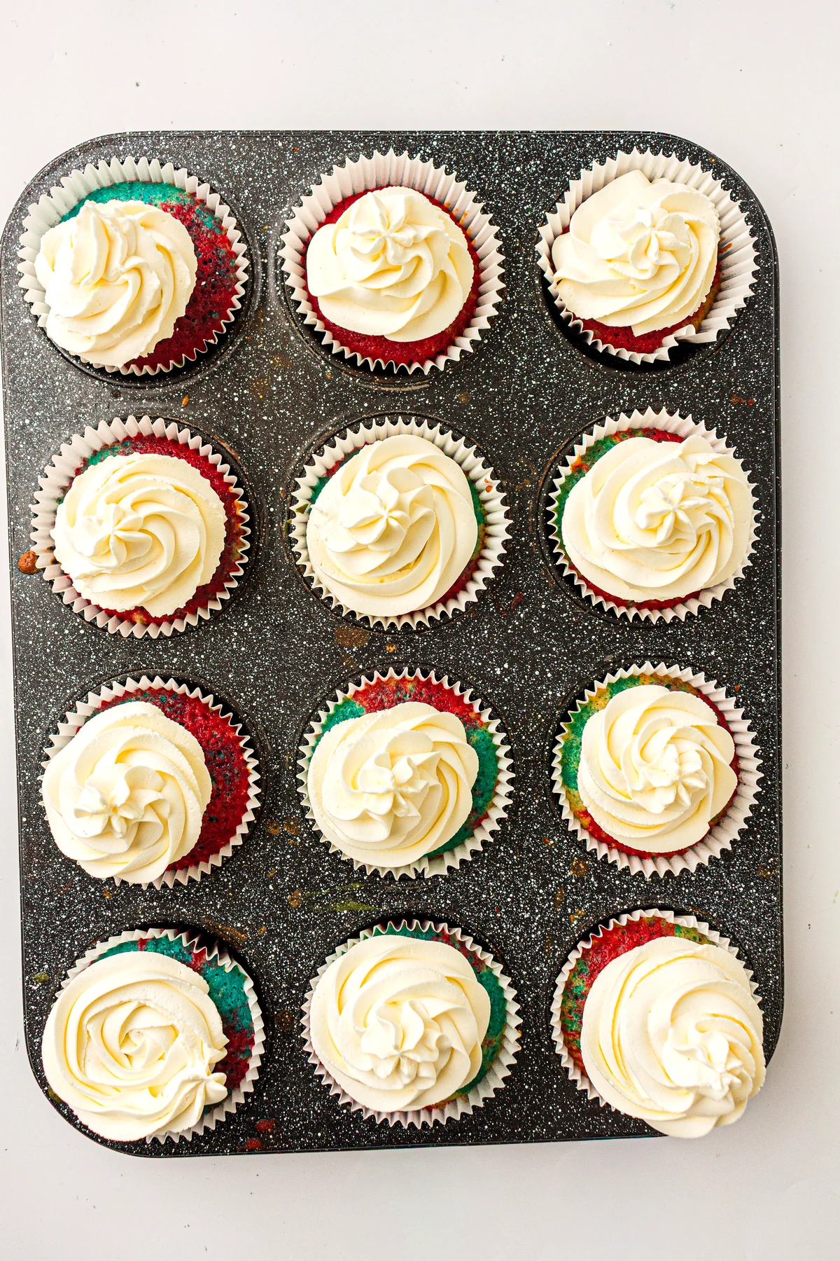 Piping buttercream onto cupcakes