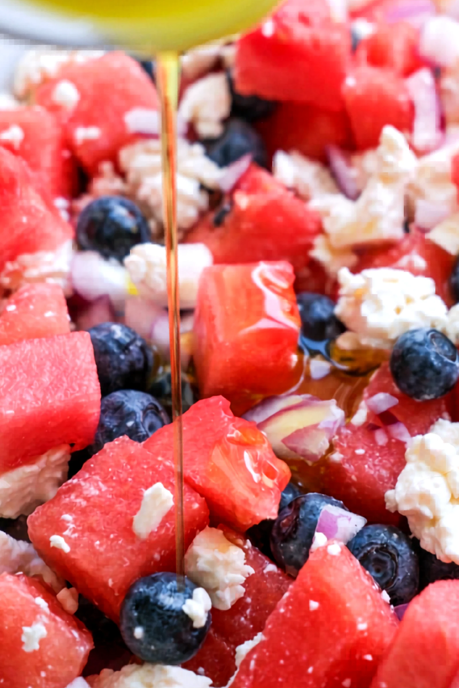 Olive oil drizzled over watermelon feta salad