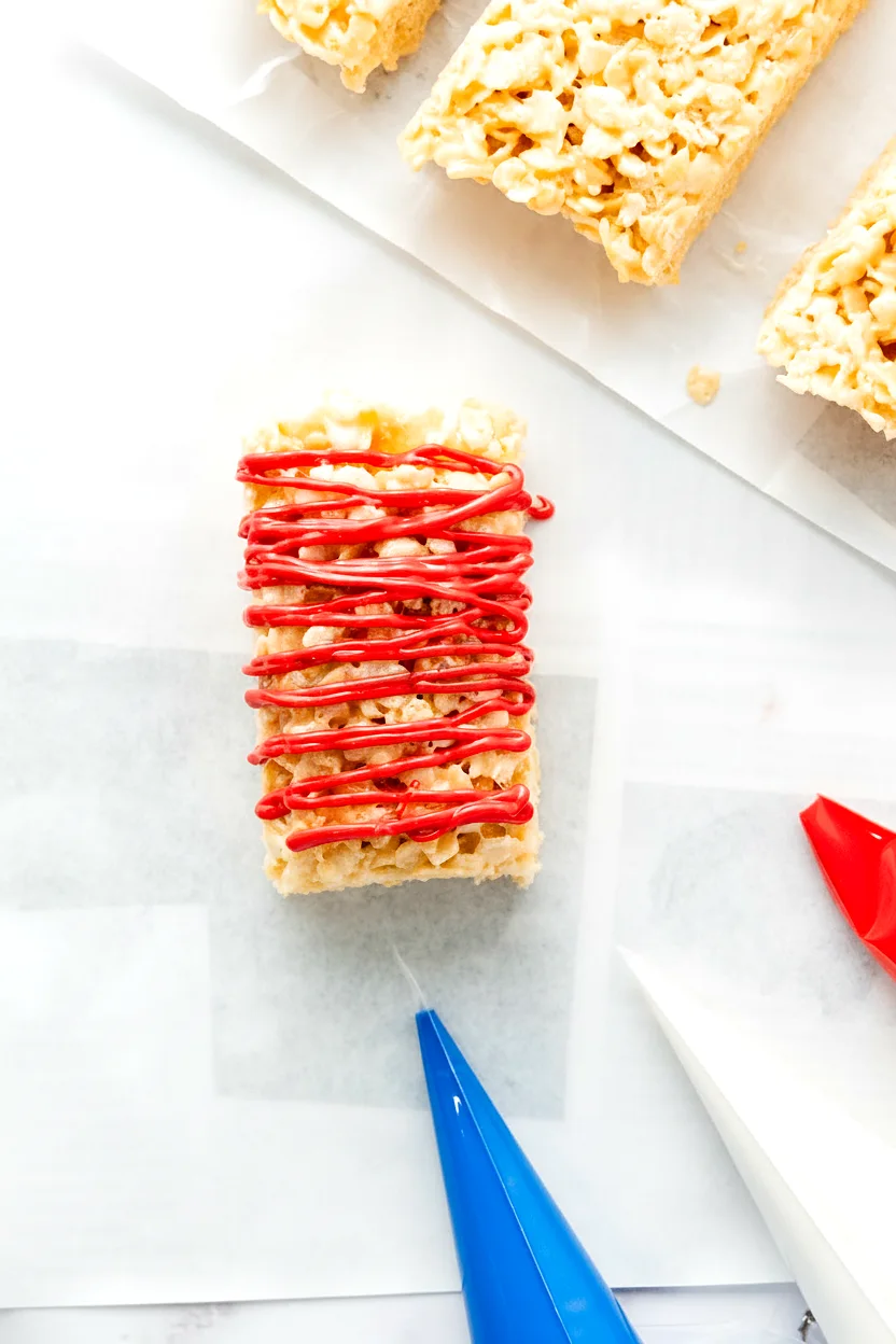 Rice Krispie treat with red candy drizzle