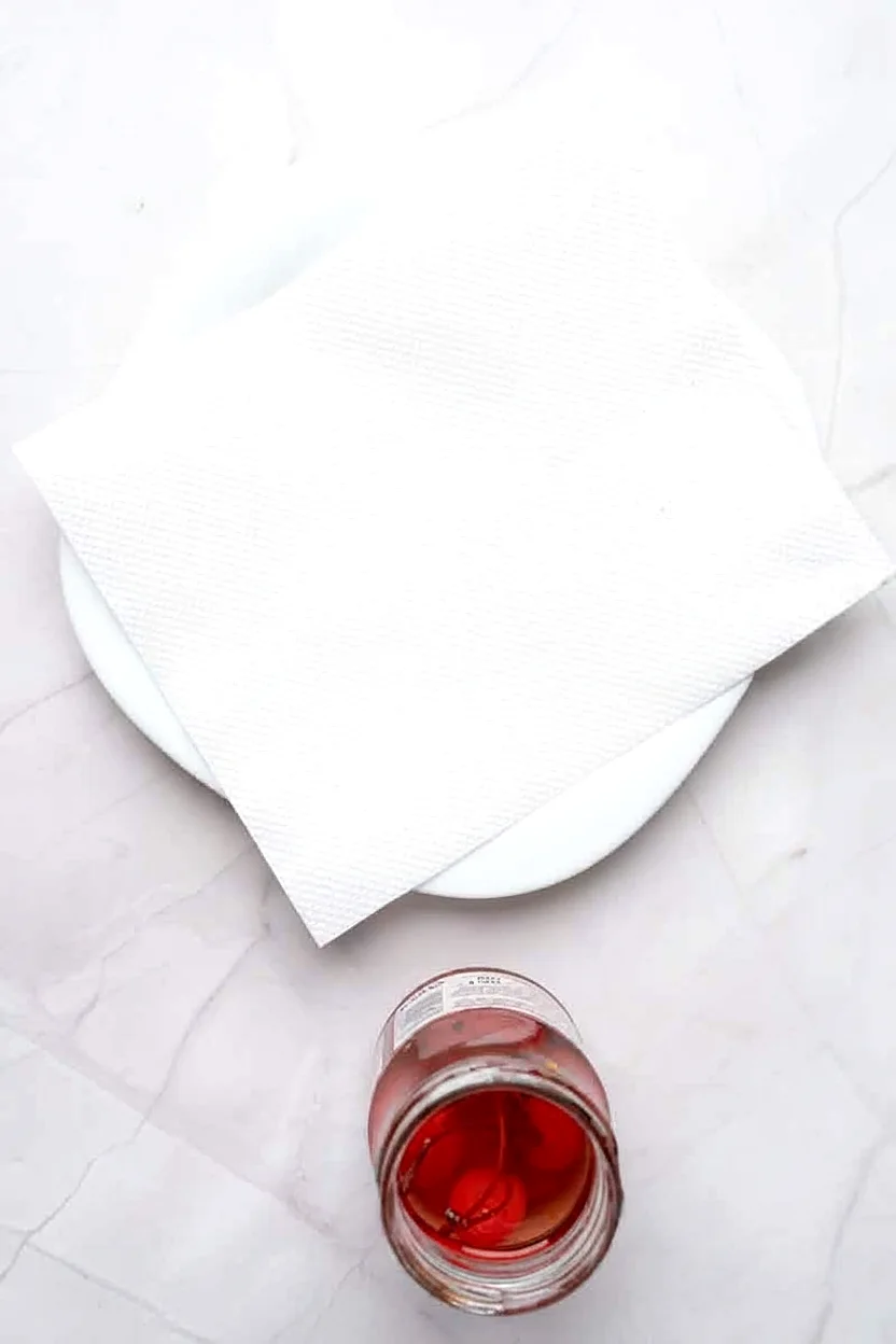 Vodka soaked cherries drained beside paper towels