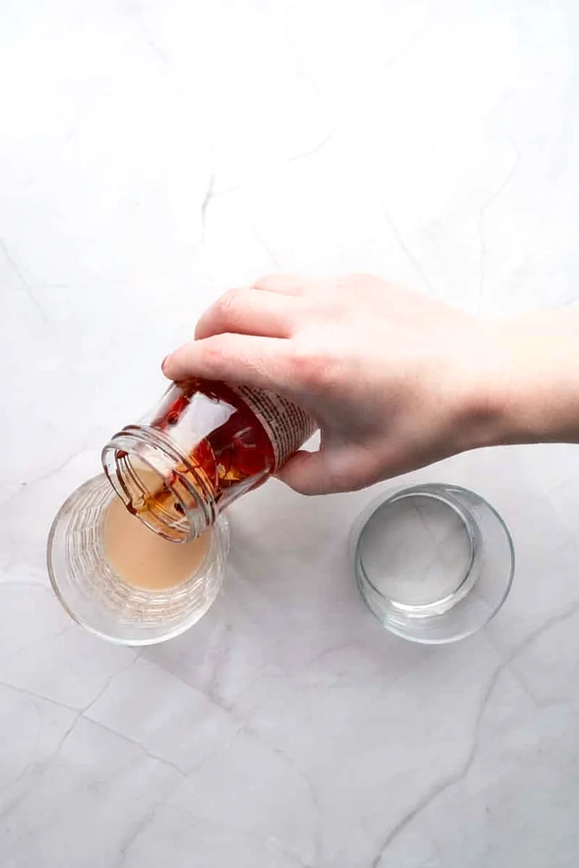 Cherry liquid being drained from a jar