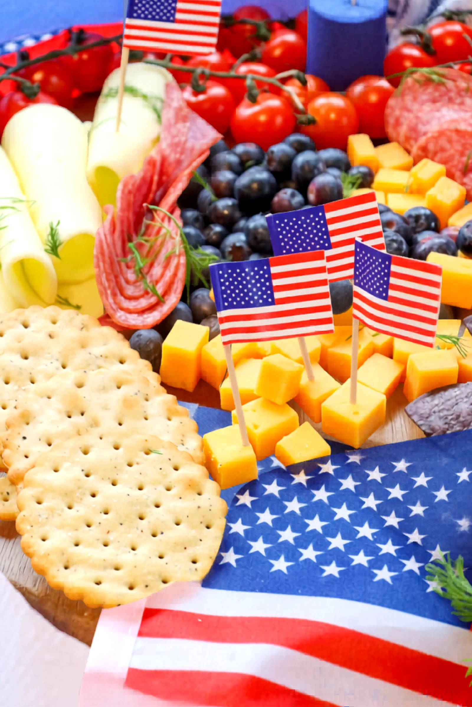Close view of cheese, crackers, and flags on the charcuterie board