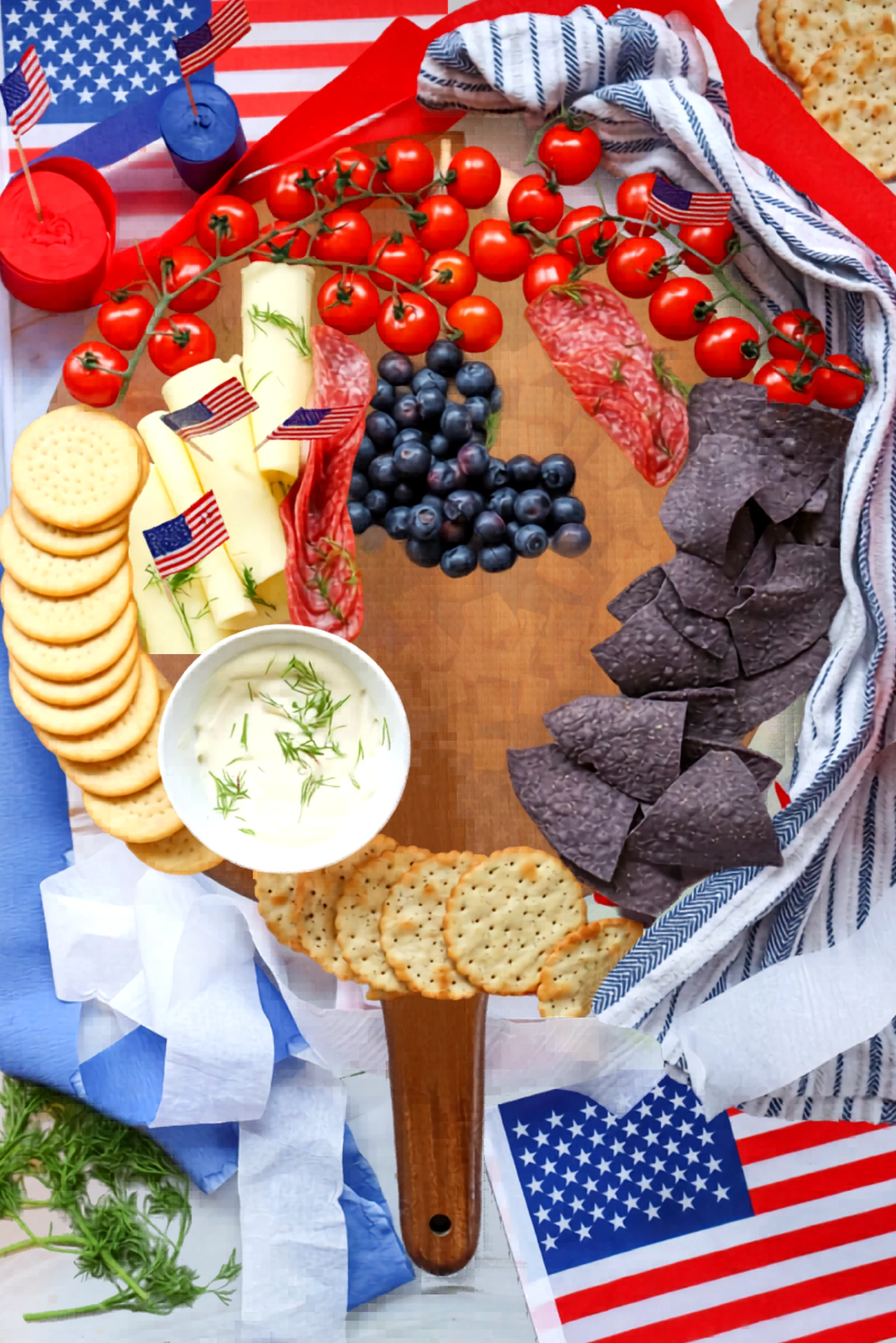 The board filled in with meats, cheese, crackers, and chips