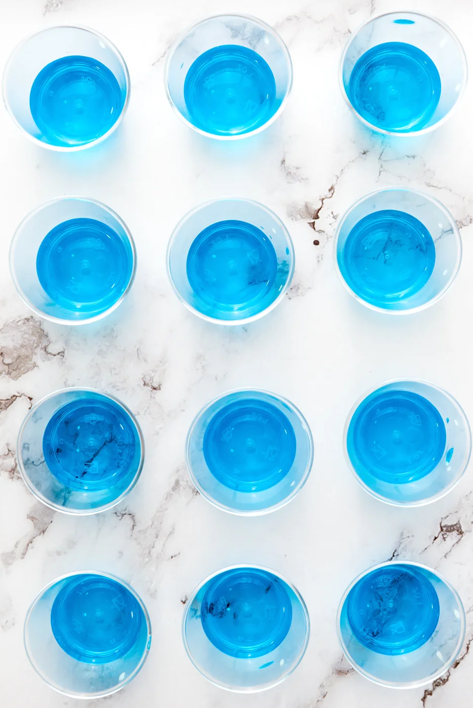 Blue gelatin layer poured into small plastic cups
