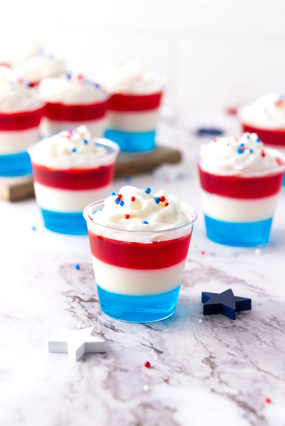 Finished patriotic Jell-O shots served cold with whipped cream and sprinkles