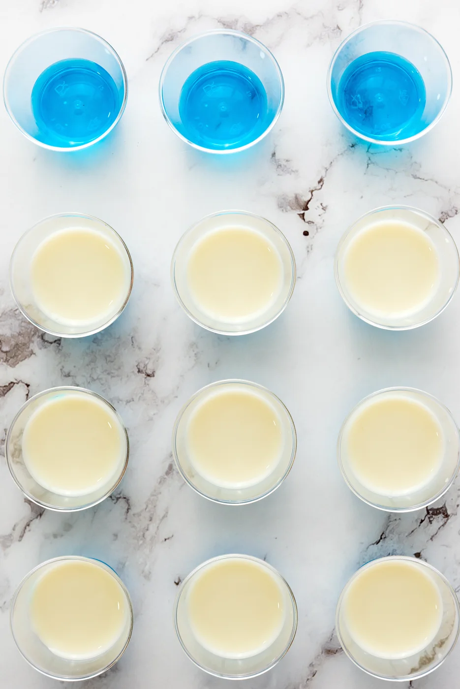 White gelatin layer poured over blue Jell-O in small cups