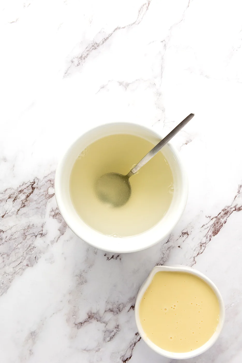 White gelatin layer being stirred in a bowl