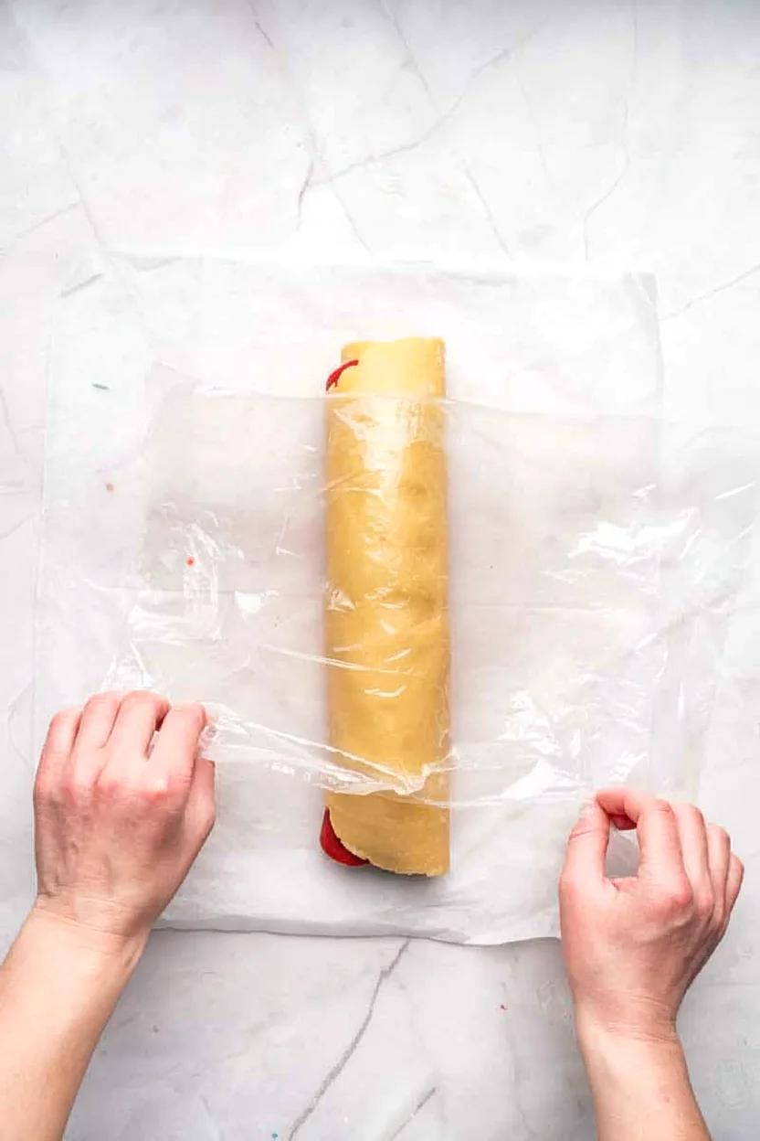 Pinwheel cookie dough log wrapped for chilling