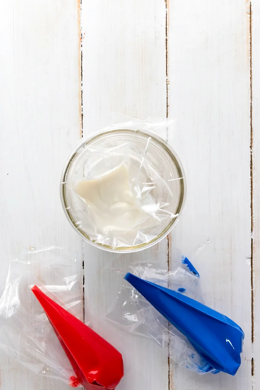 Piping bags filled with red white and blue candy melts