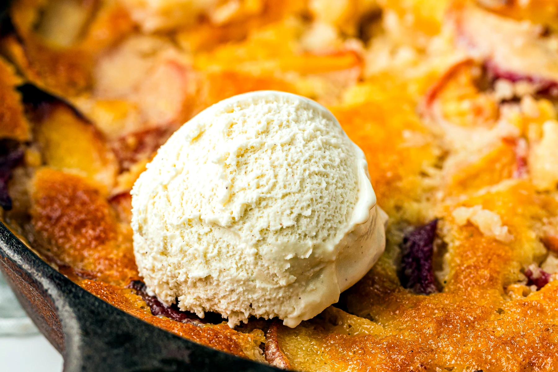 Warm peach cobbler served with ice cream