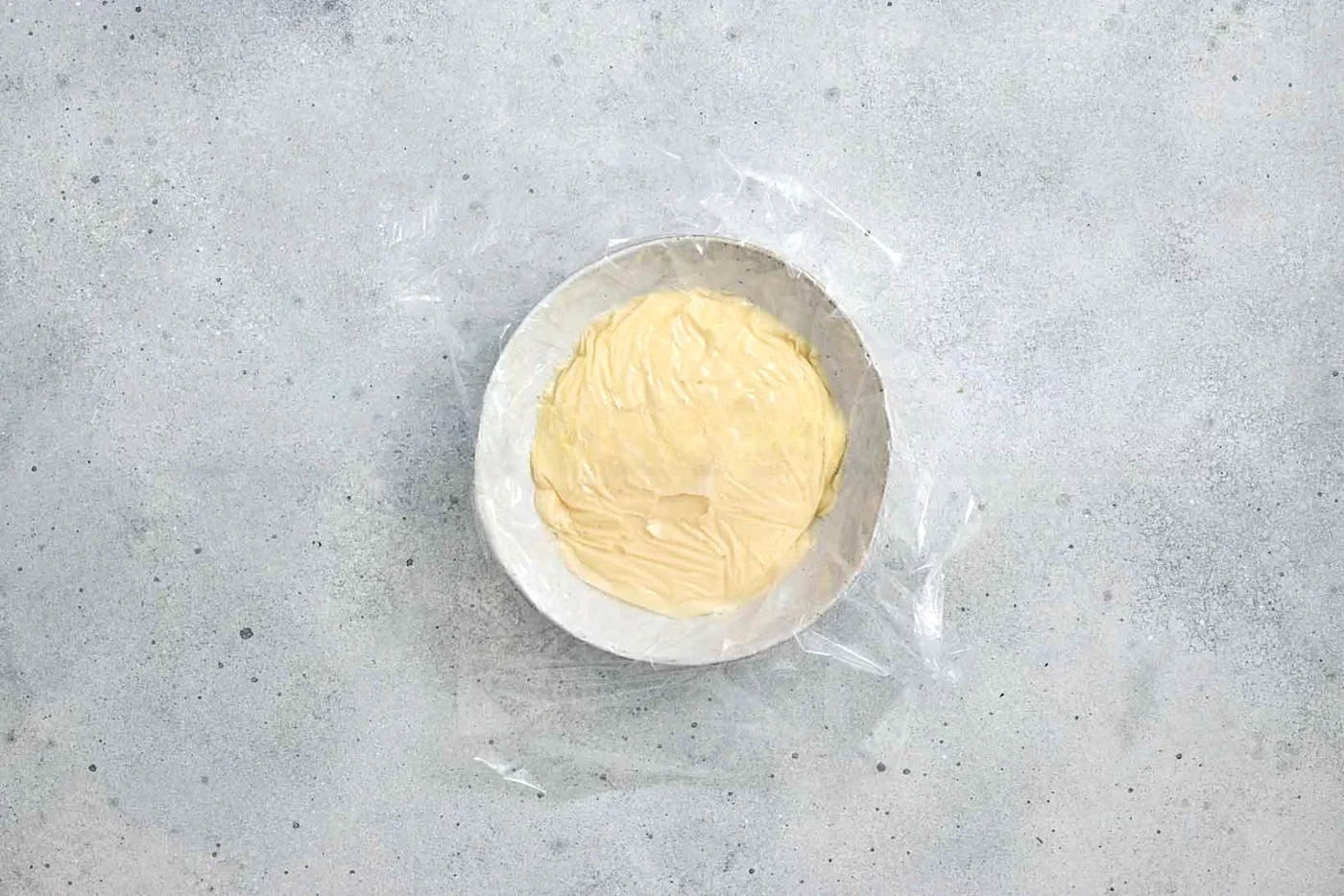 Cake batter spread in a lined cake pan