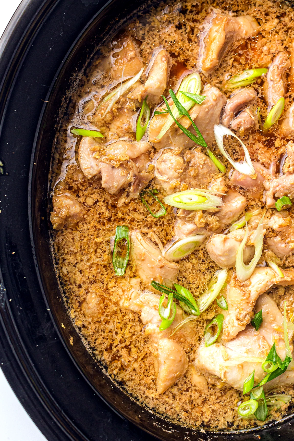 Scallions added to slow cooker honey garlic chicken