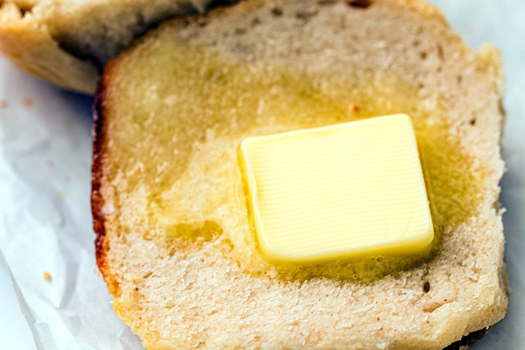Buttered sourdough dinner roll cut open