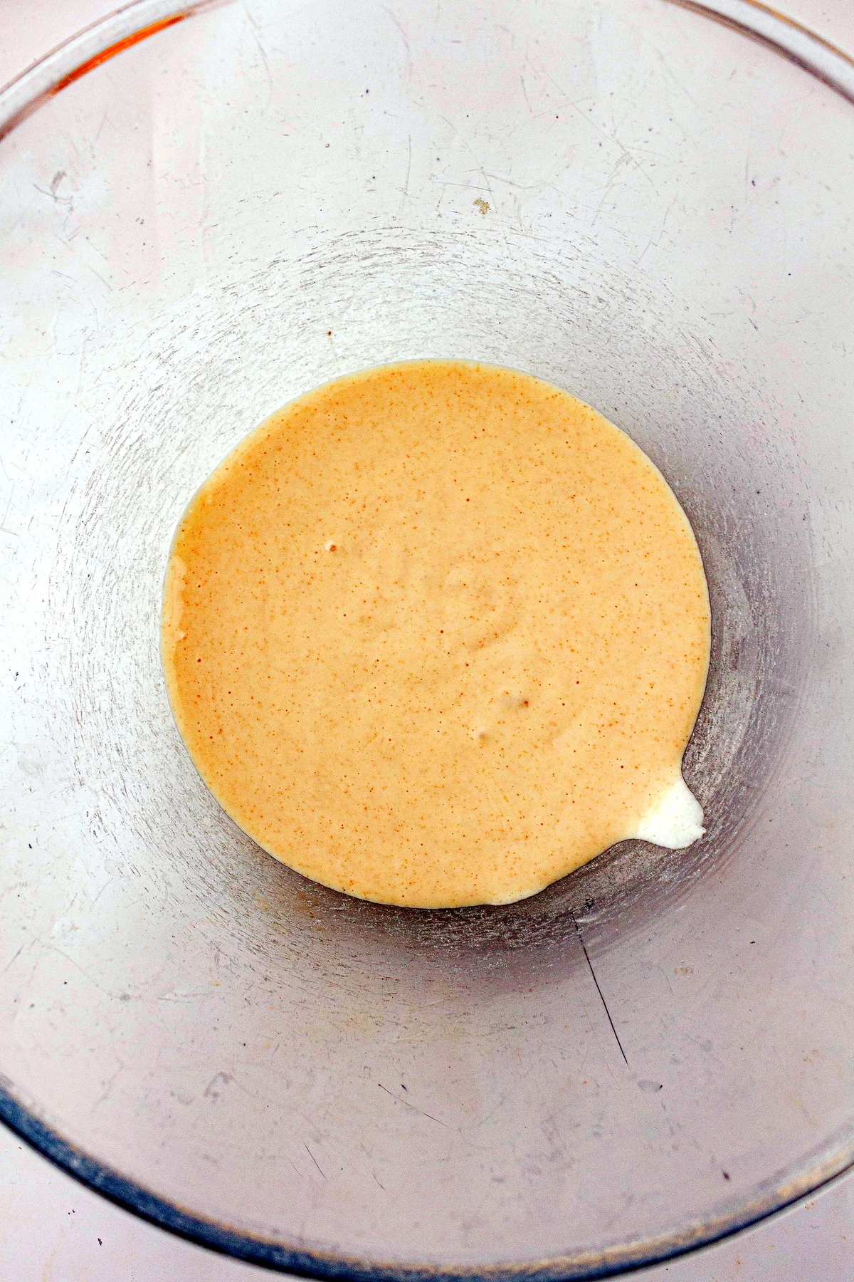 Warm milk and sourdough starter in a mixing bowl