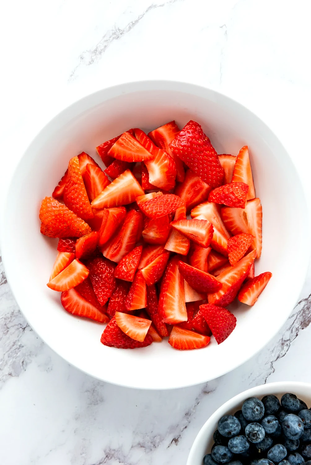Sliced strawberries ready for star spangled fruit salad