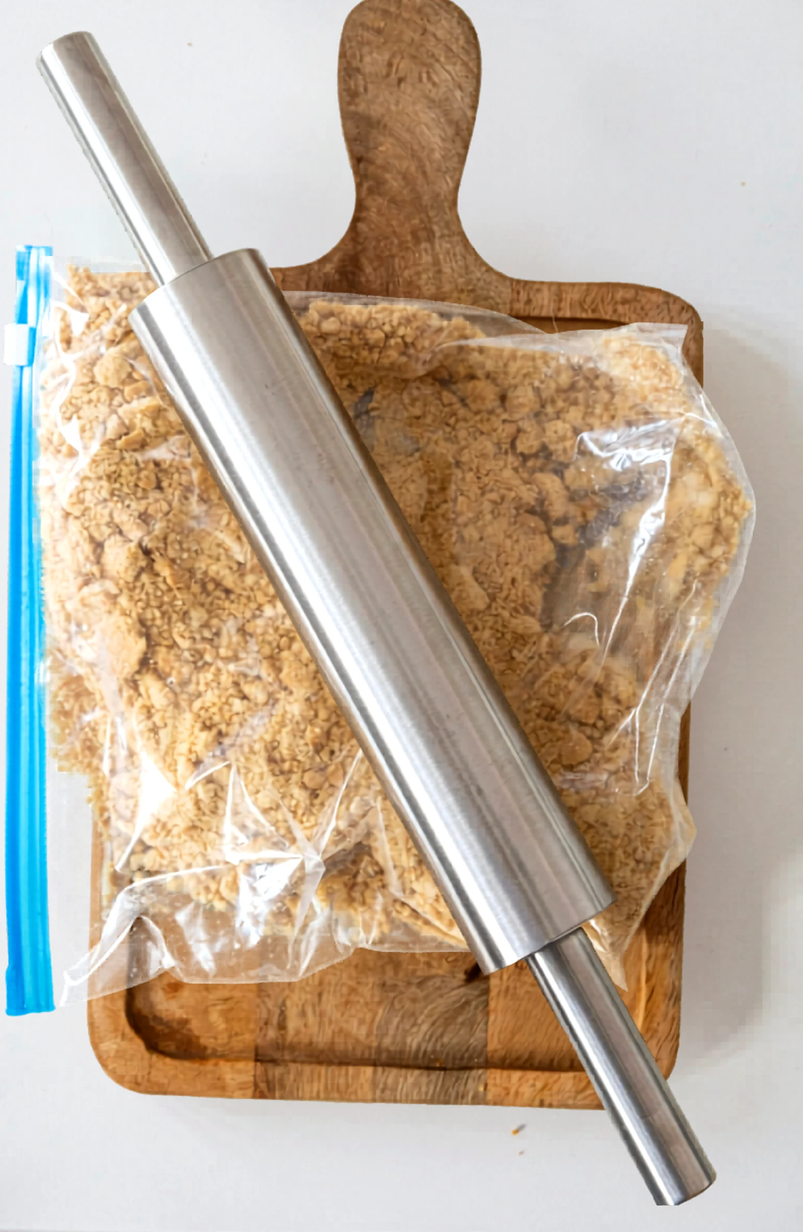 Crushed graham crackers in a zip bag with a rolling pin.