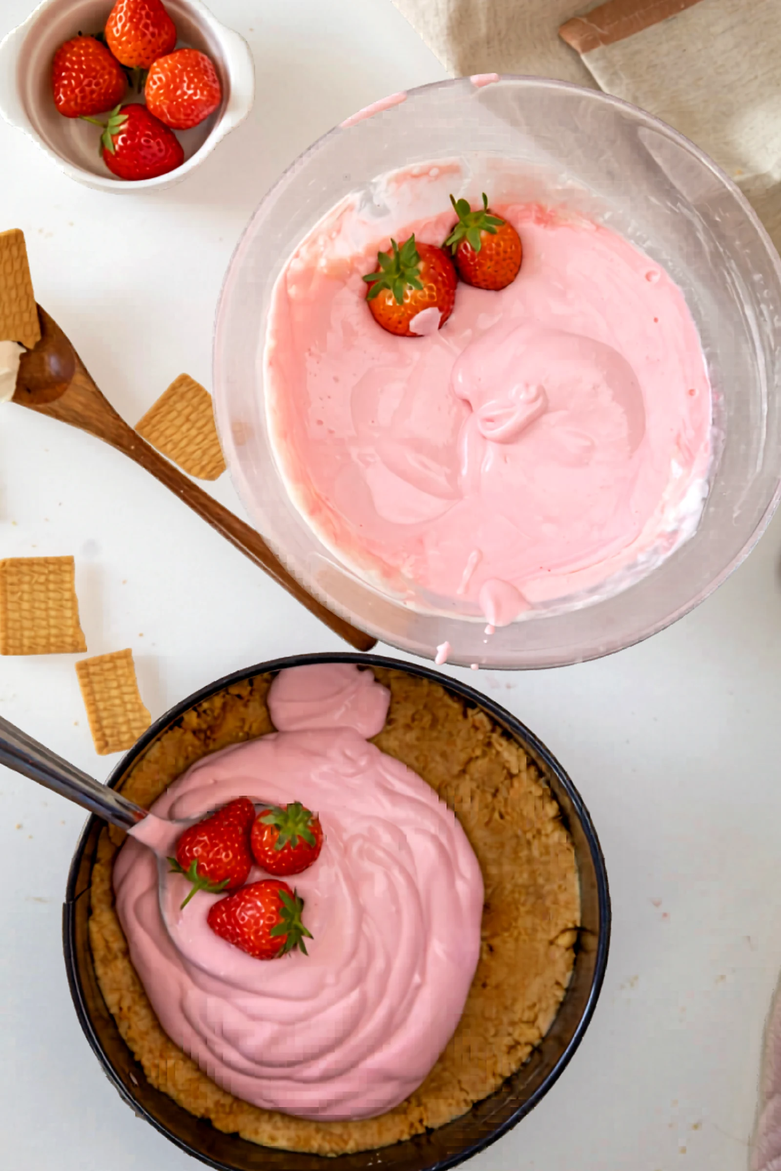 More strawberry cheesecake filling being added into the crust.