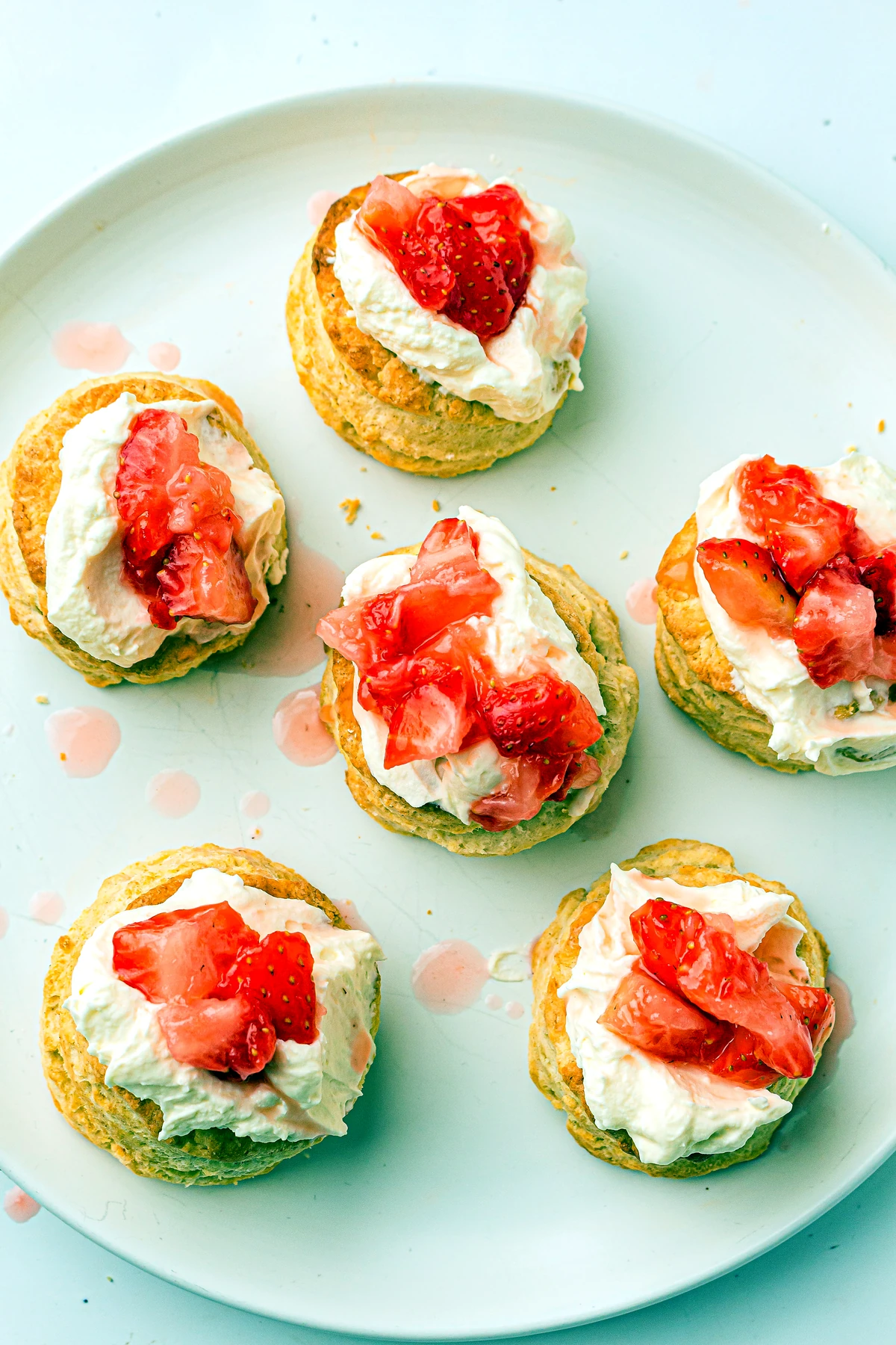 Strawberries spooned onto shortcake biscuits