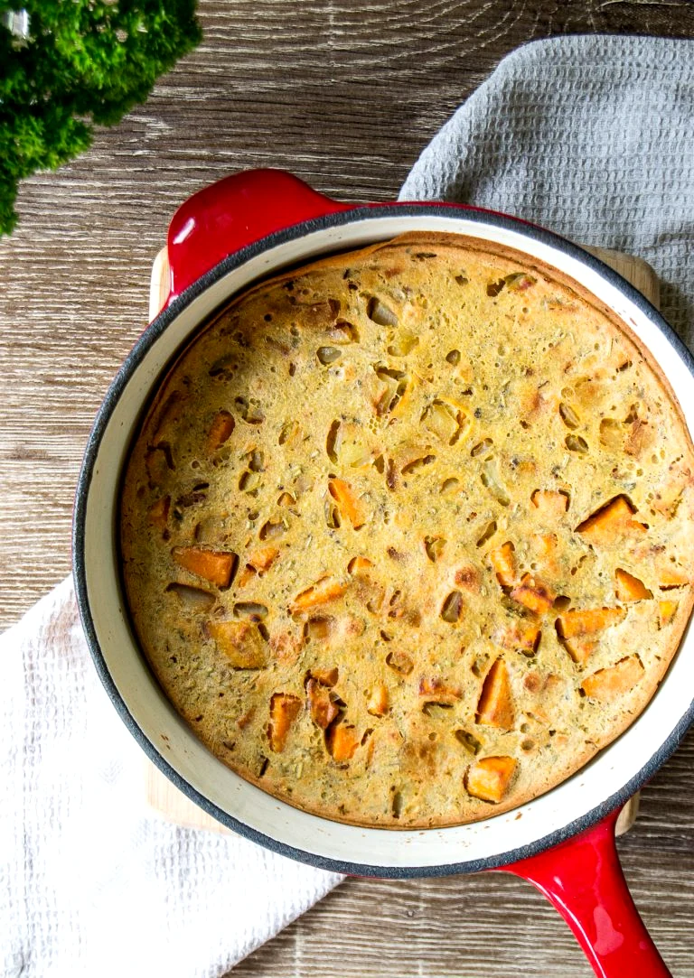 Baking vegan sweet potato frittata in a cast iron pan