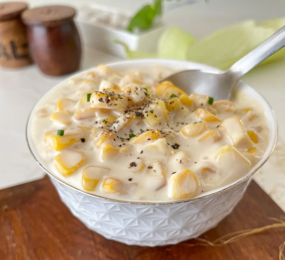 Close view of fresh corn kernels in a creamy homemade sauce