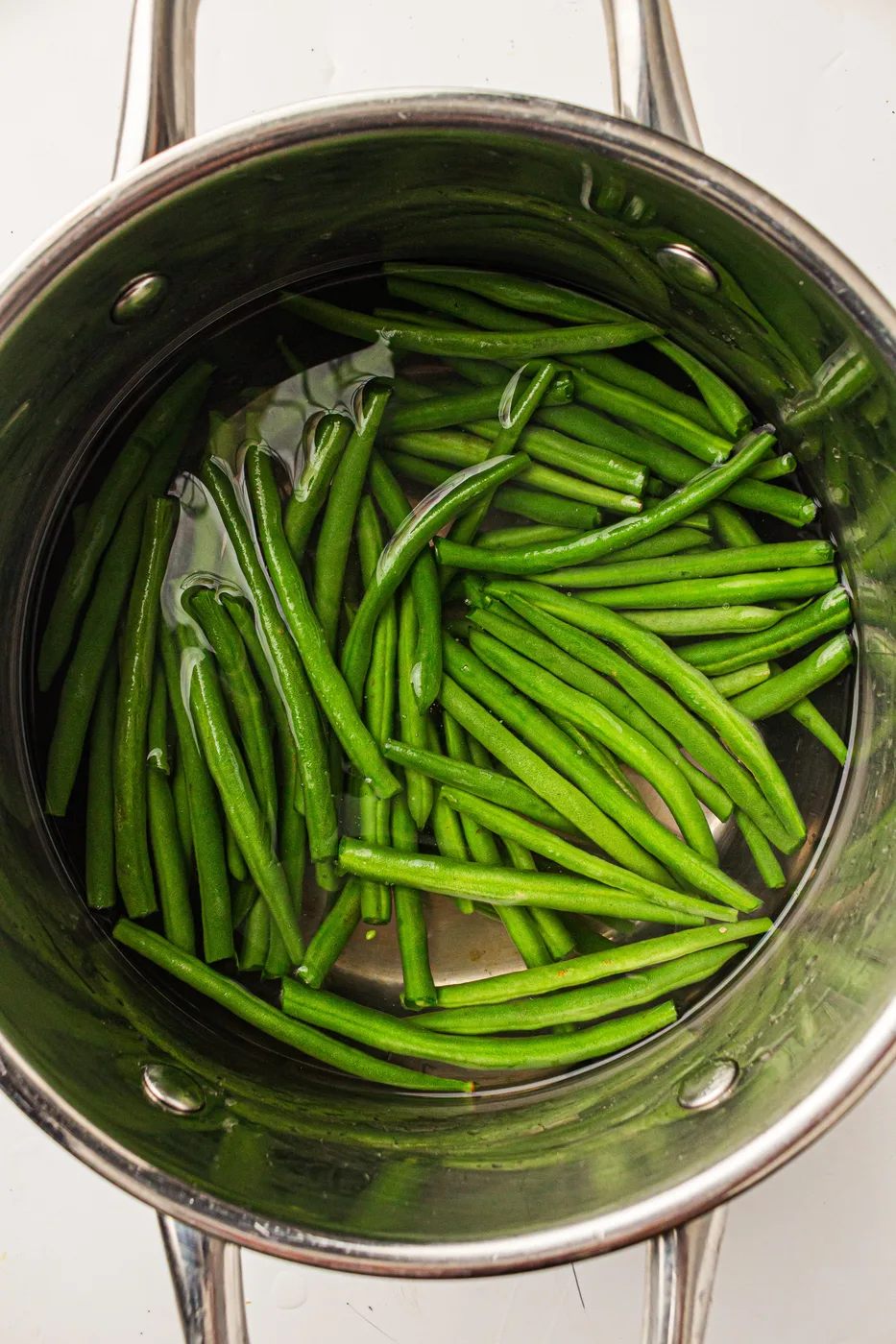 Green beans blanching in a pot of hot water