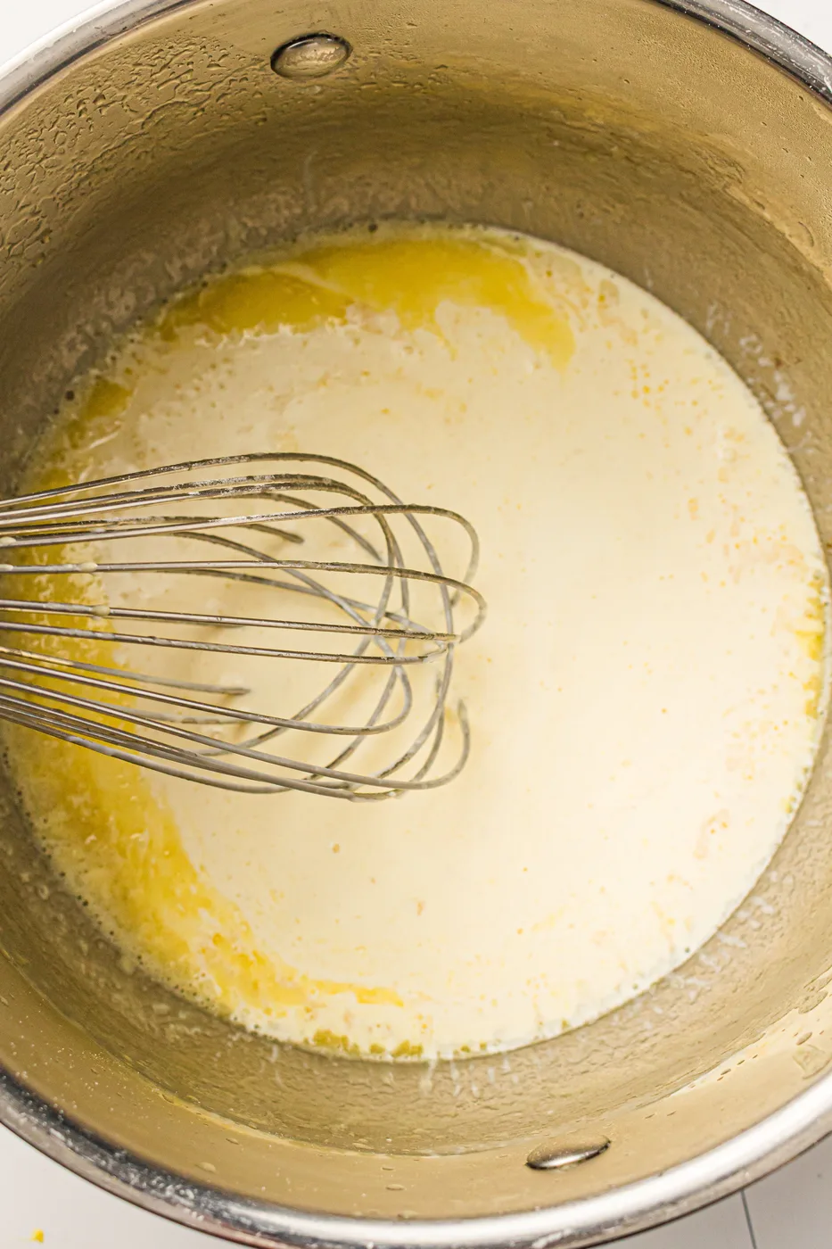 Whole milk added gradually to the butter and flour sauce