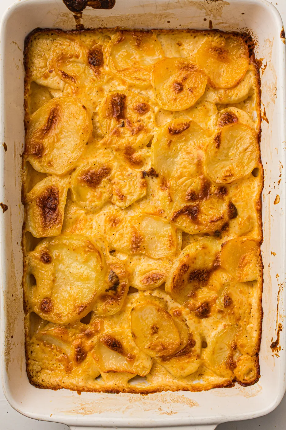 Golden baked scalloped potatoes in a rectangular casserole dish