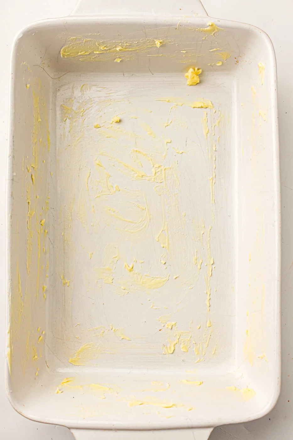 Rectangular baking dish coated with butter