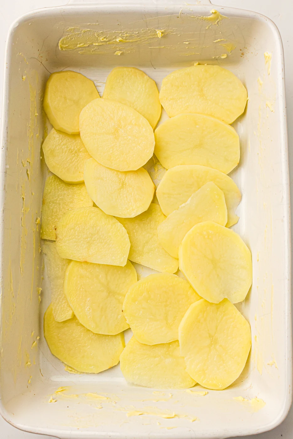 Thin potato slices arranged in the first overlapping layer