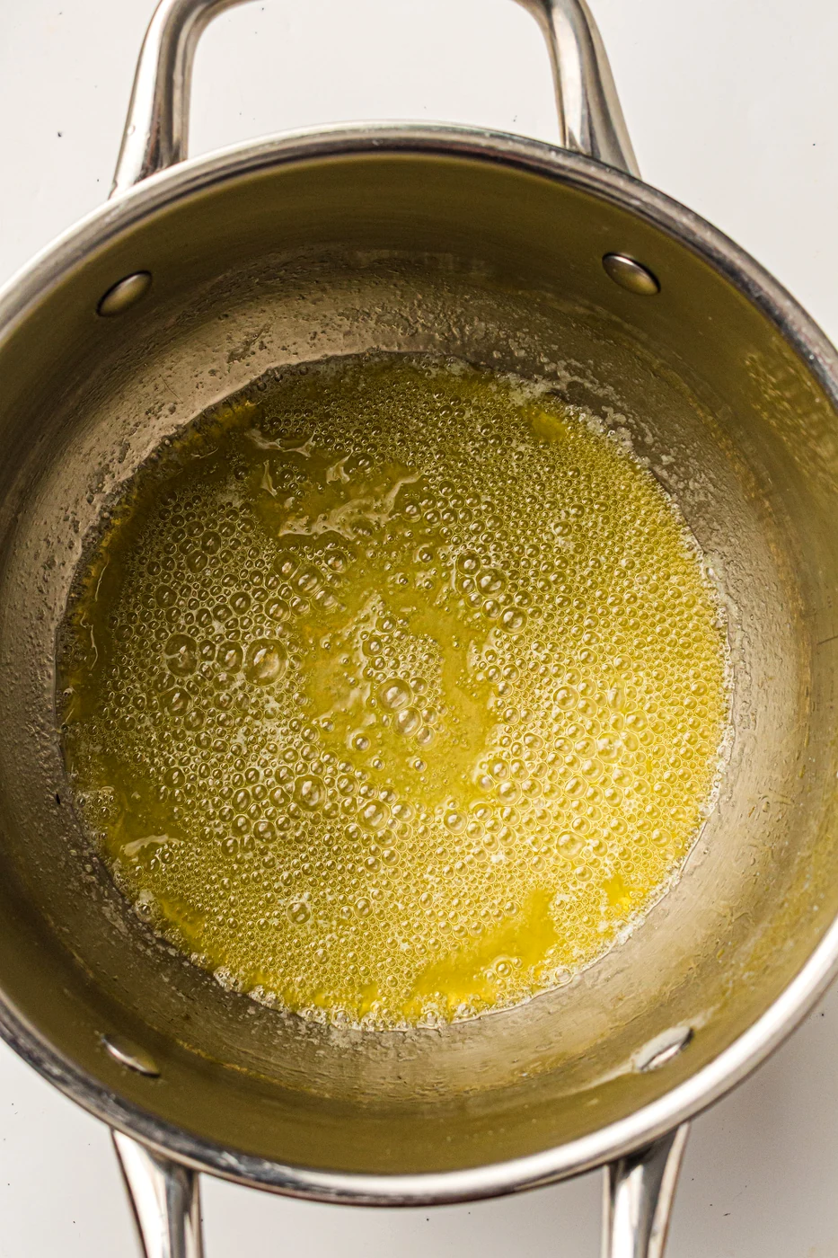 Butter melting in a saucepan for creamy scalloped potatoes