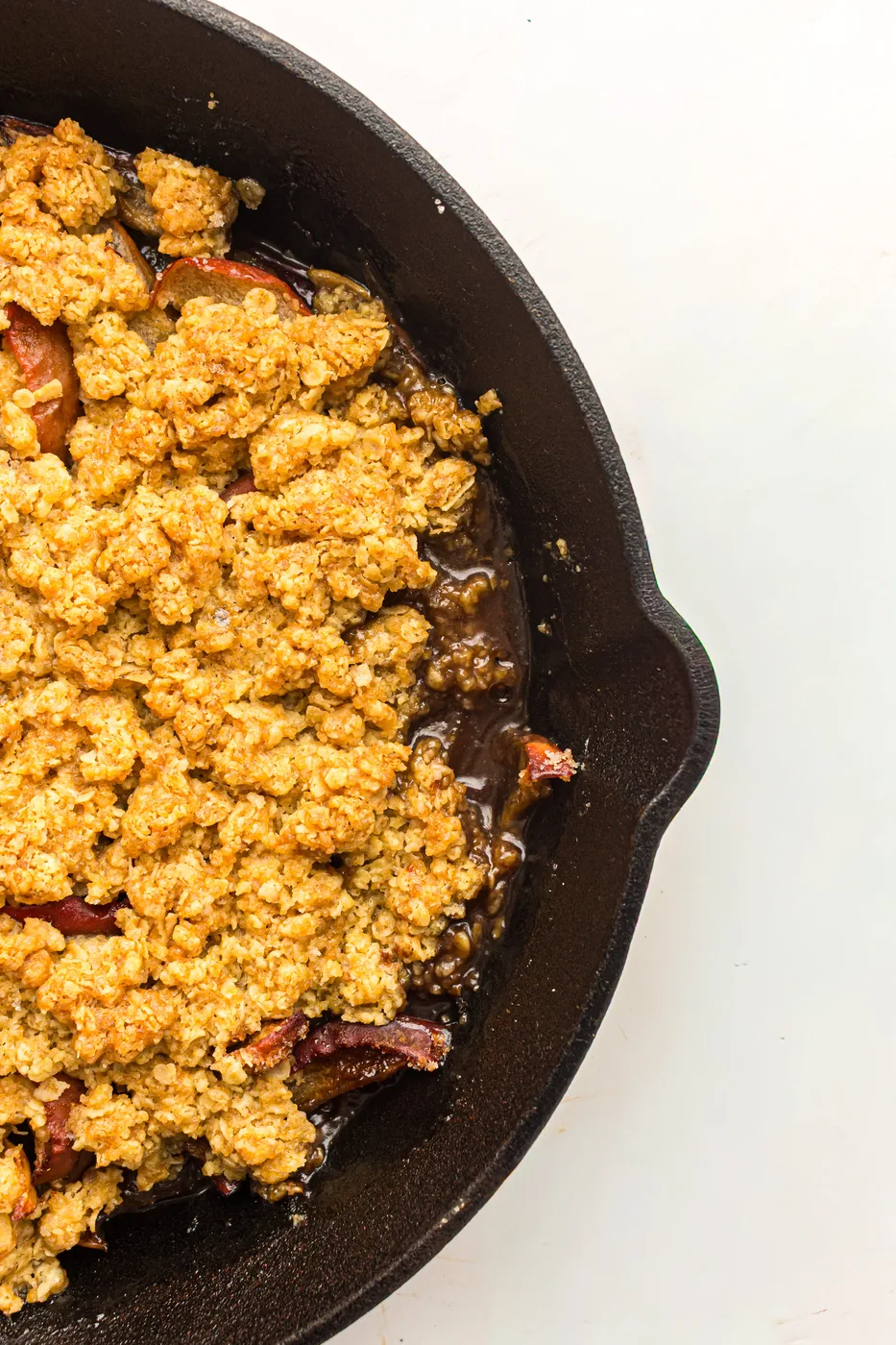 Golden baked apple crisp bubbling in a cast-iron skillet