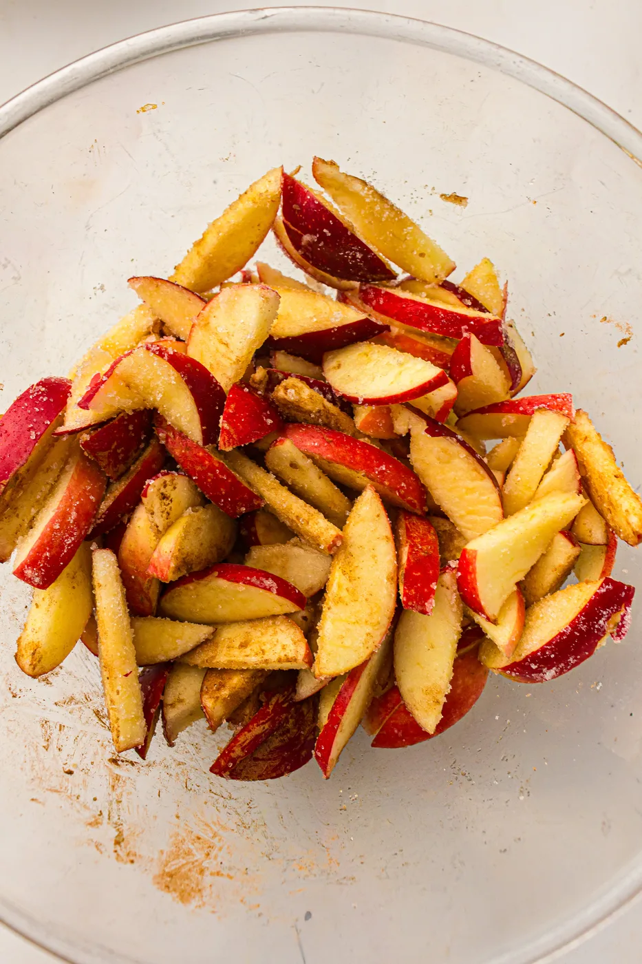 Sliced apples coated with sugar, flour, cinnamon, and melted butter