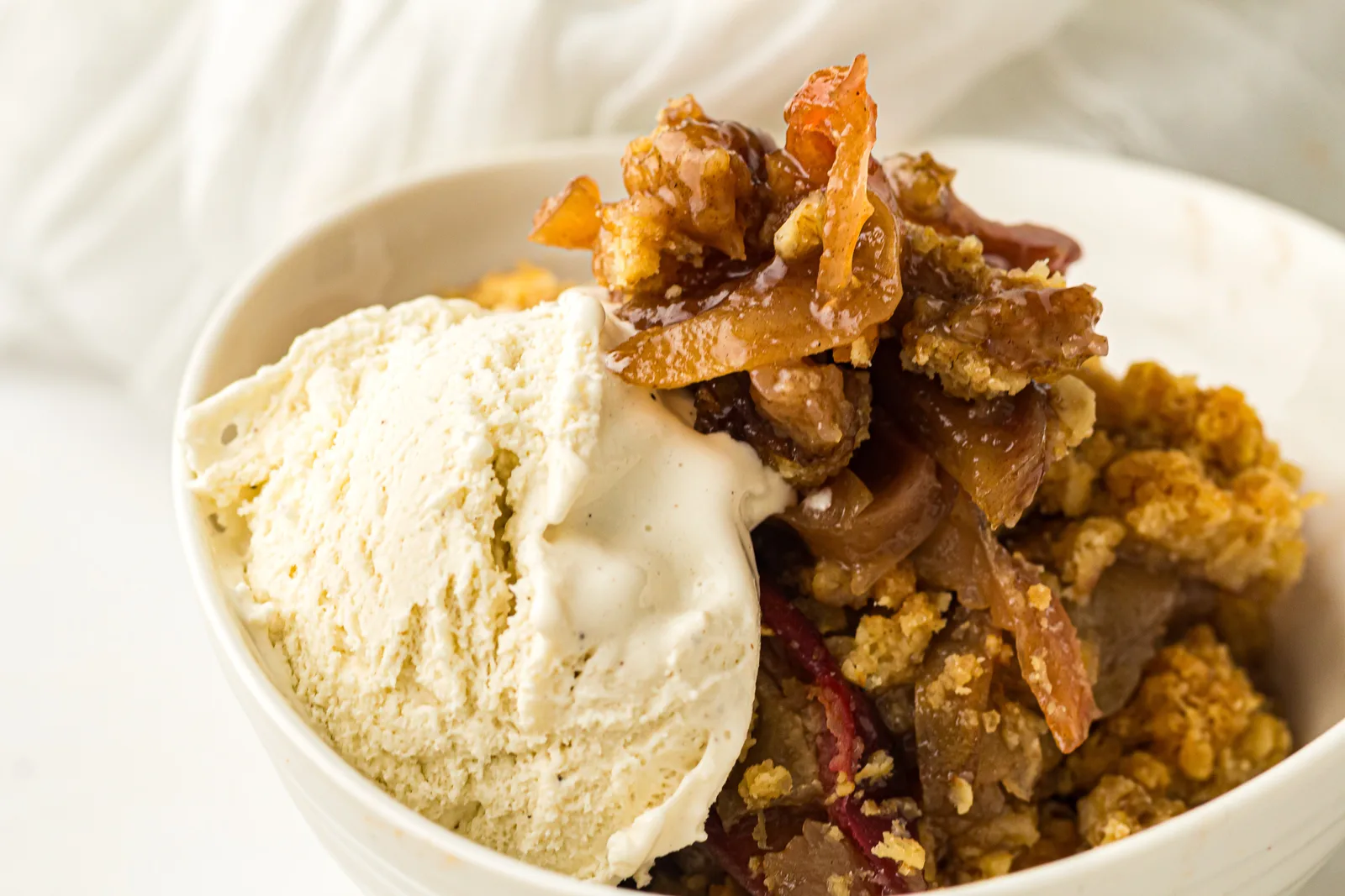 Warm skillet apple crisp served with a scoop of vanilla ice cream
